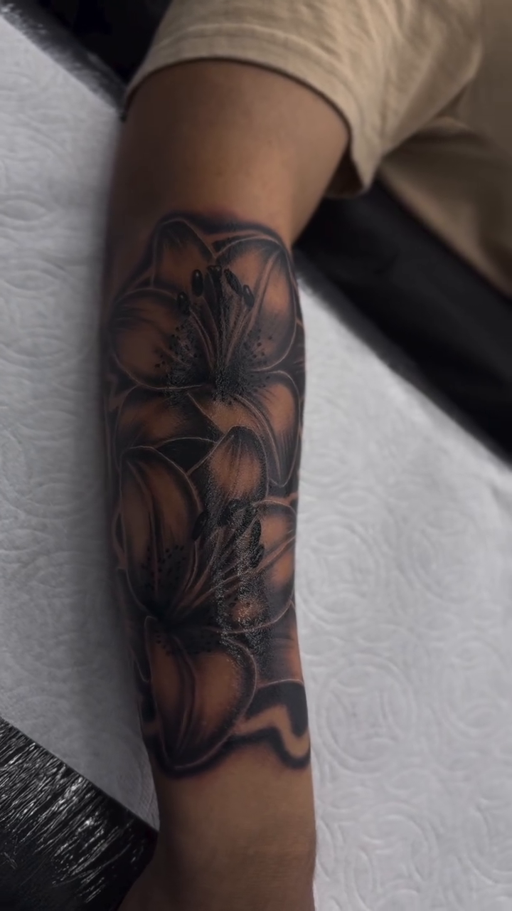 Lilies realism tattoo by Alex Romero
