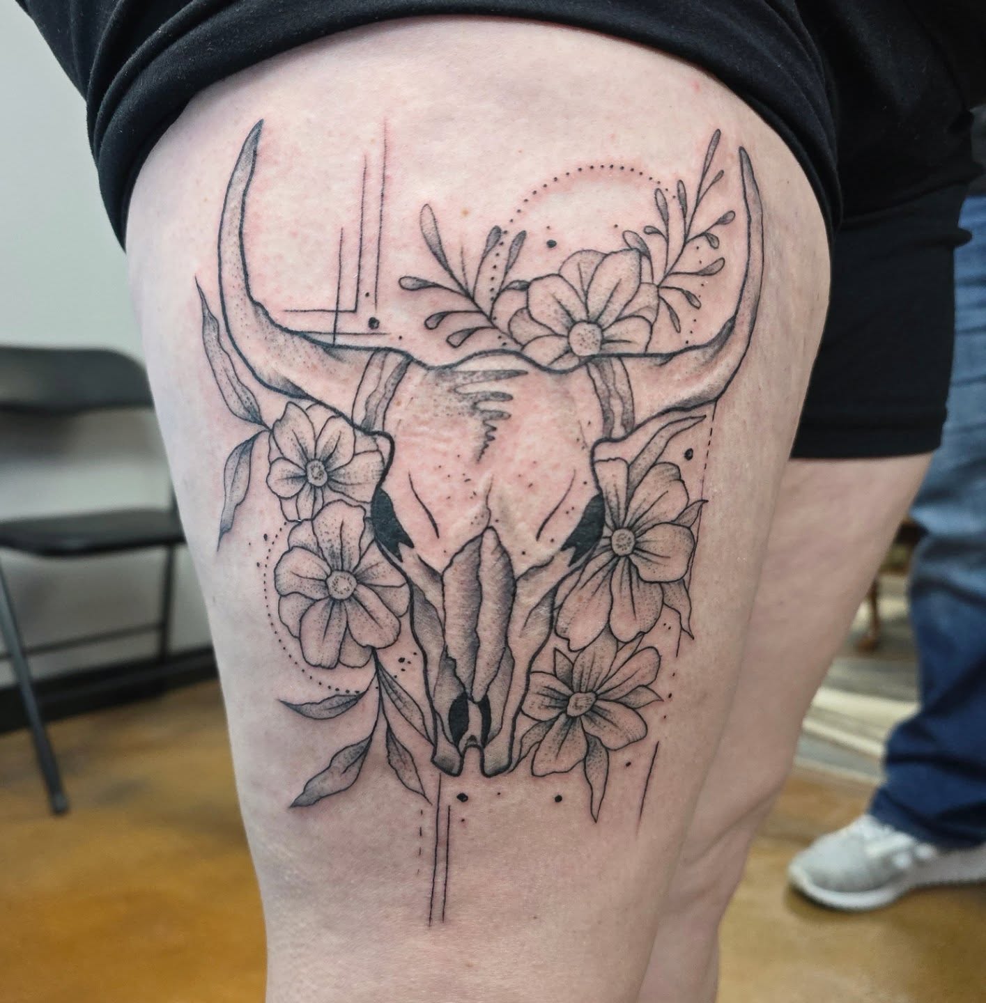 Deer skull with flowers dotwork tattoo on the thigh by Jon Griffin, Maryville, Tennessee