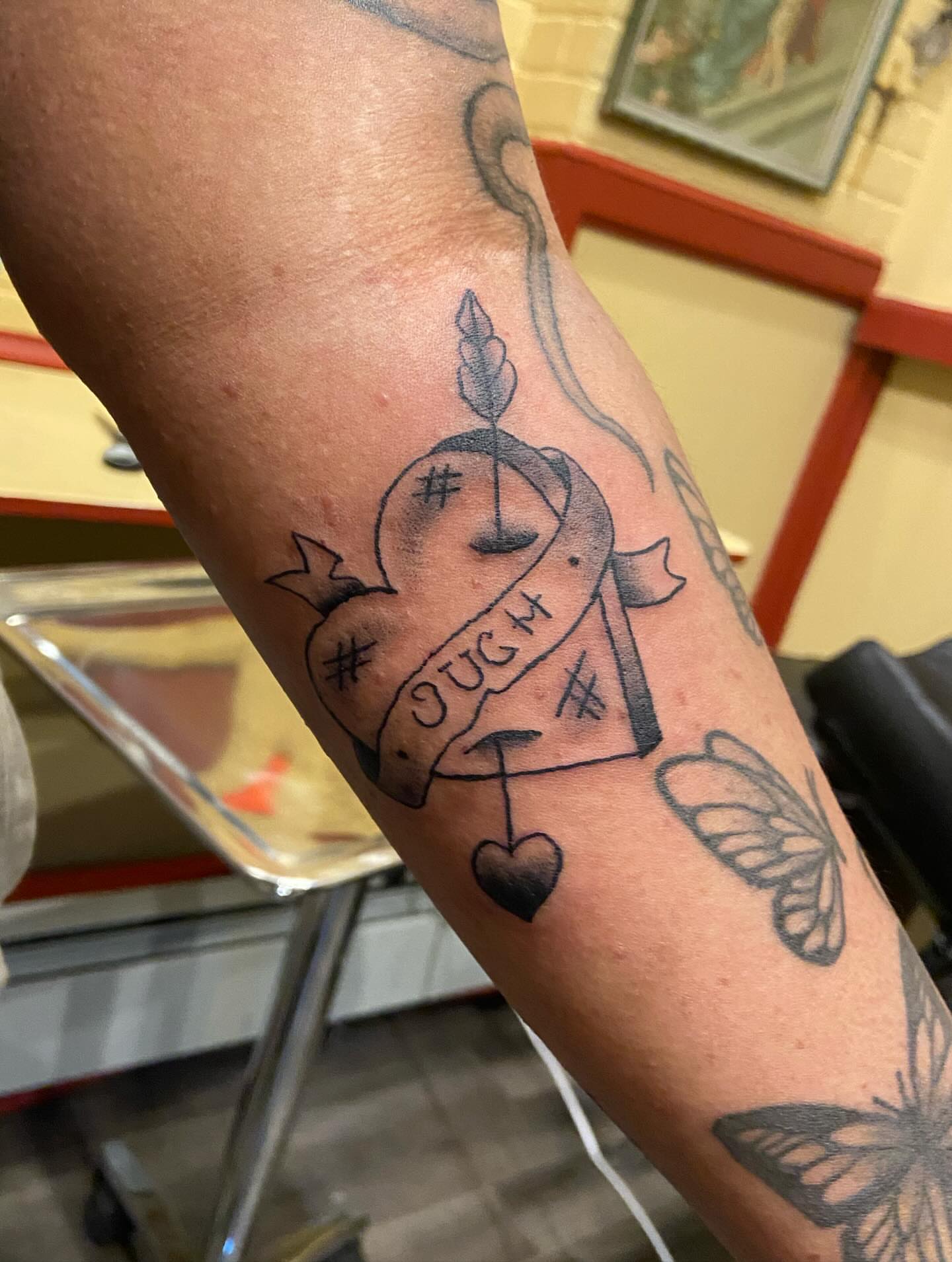 Heart with banner black and grey tattoo on the forearm by 🐆Cam Feral Tattoos