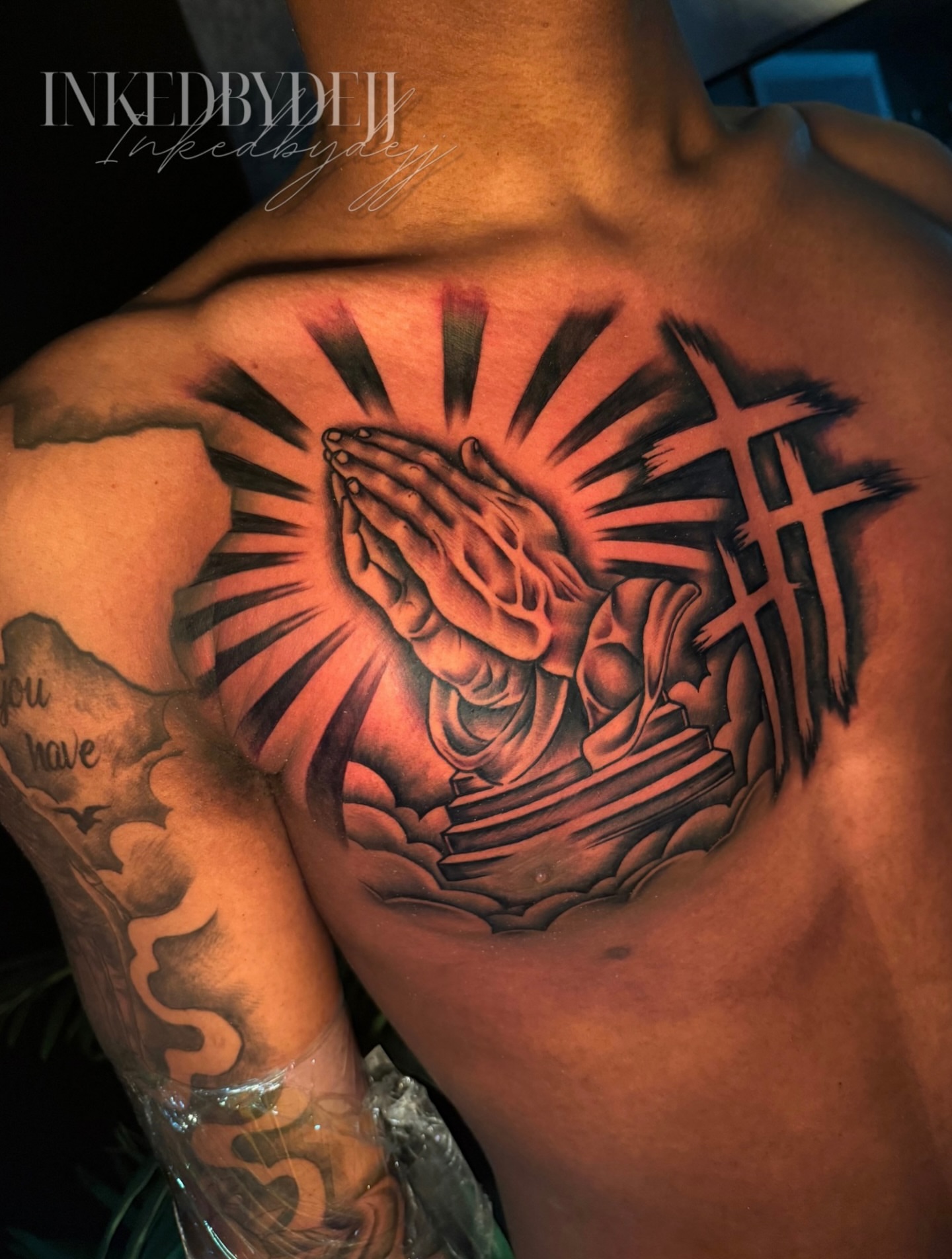 Praying hands realism tattoo on the chest by Inkedbydejj