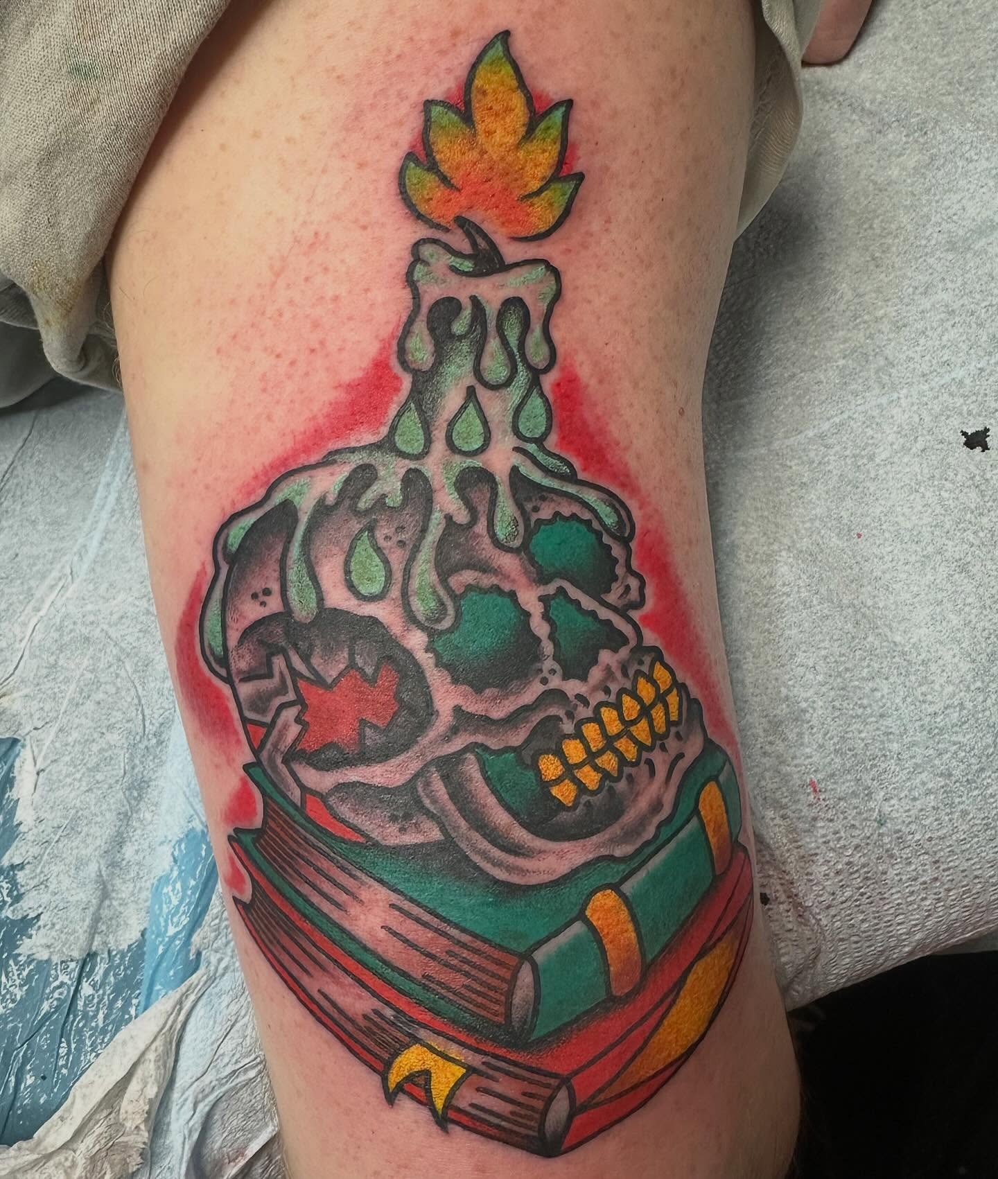 Skull with candle American traditional tattoo on the thigh by Devin Spenny