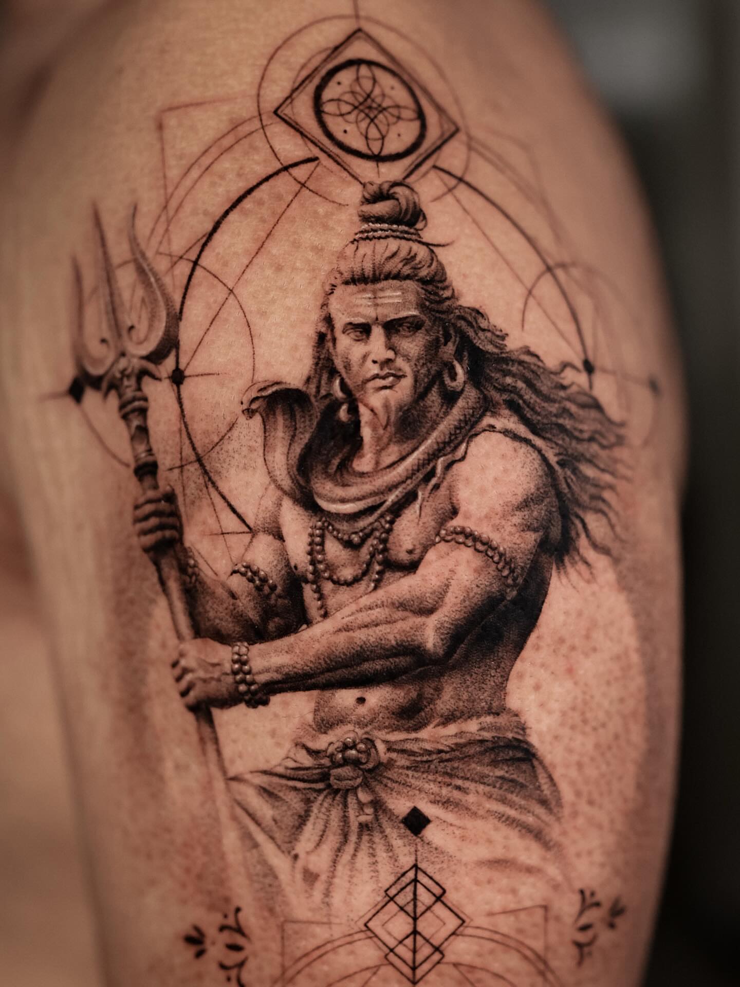 Hindu deity shiva realism tattoo on the thigh by Nikita Grinenko, San Francisco