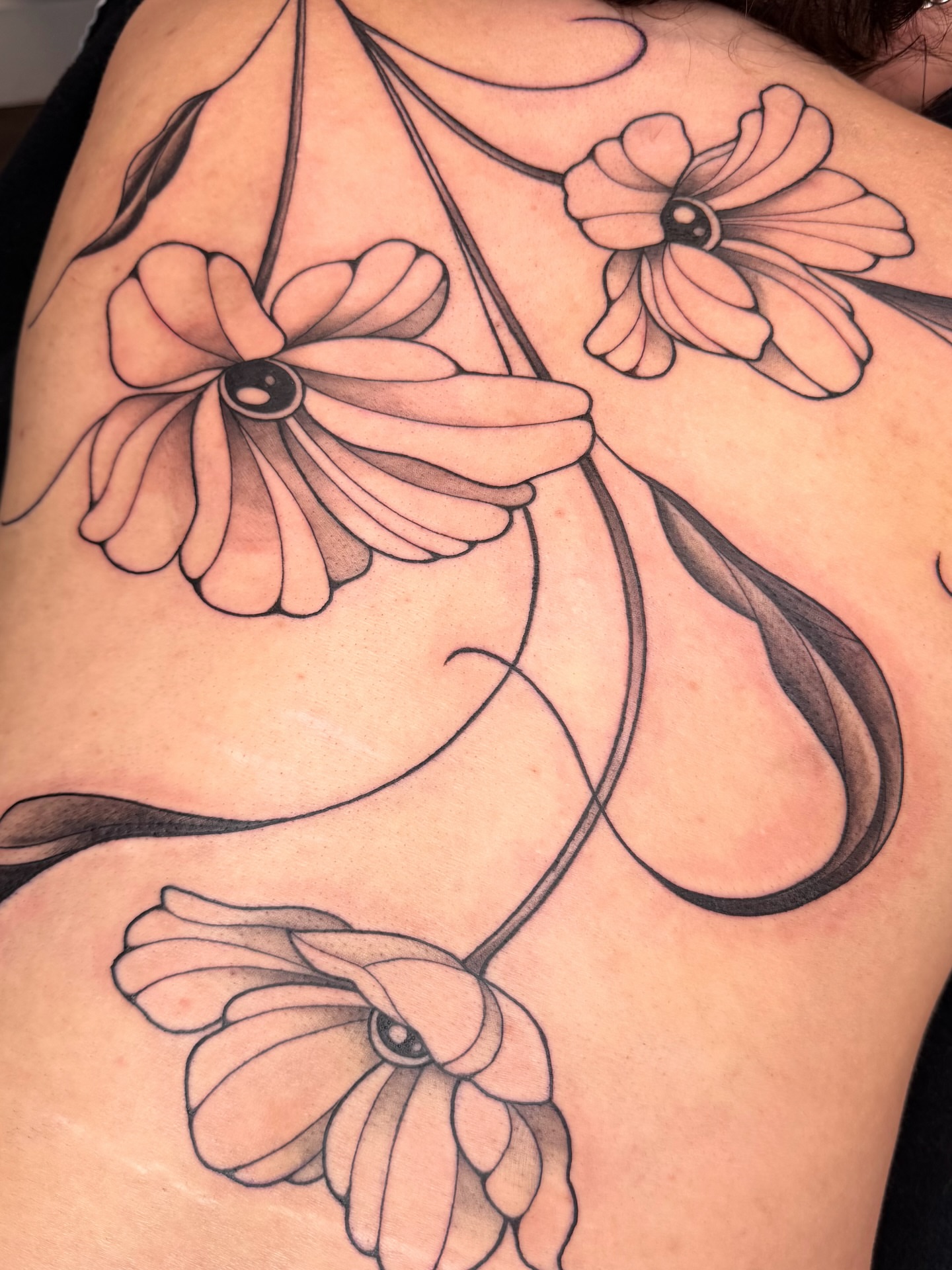 Flowers black and grey tattoo on the shoulder by Red