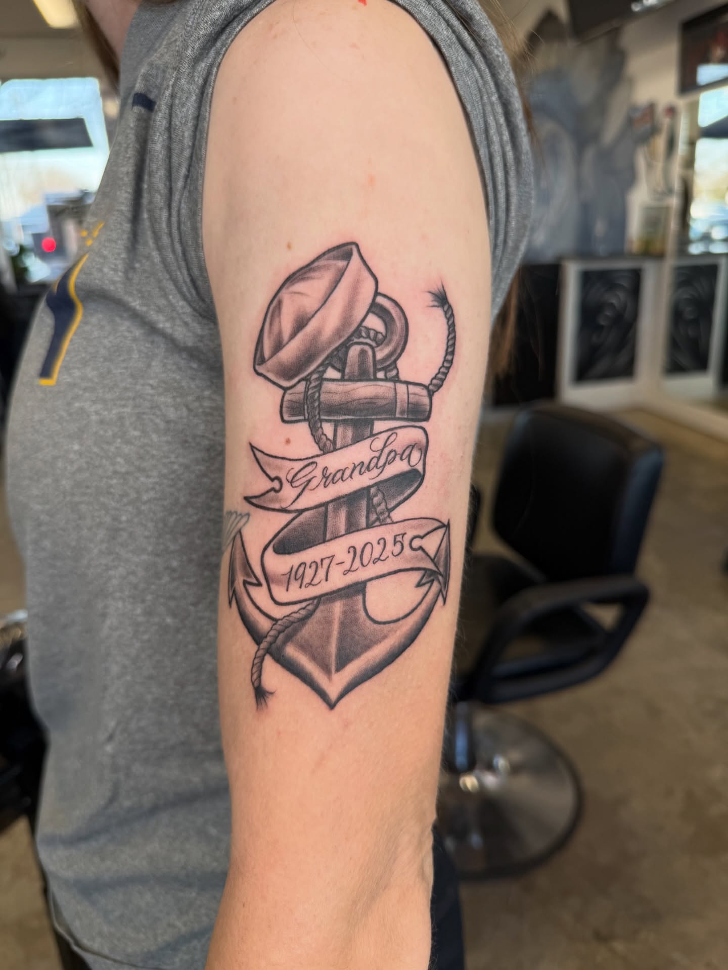 Anchor with ribbon black and grey tattoo on the forearm by Ricky Sanchez, Duncanville, Texas