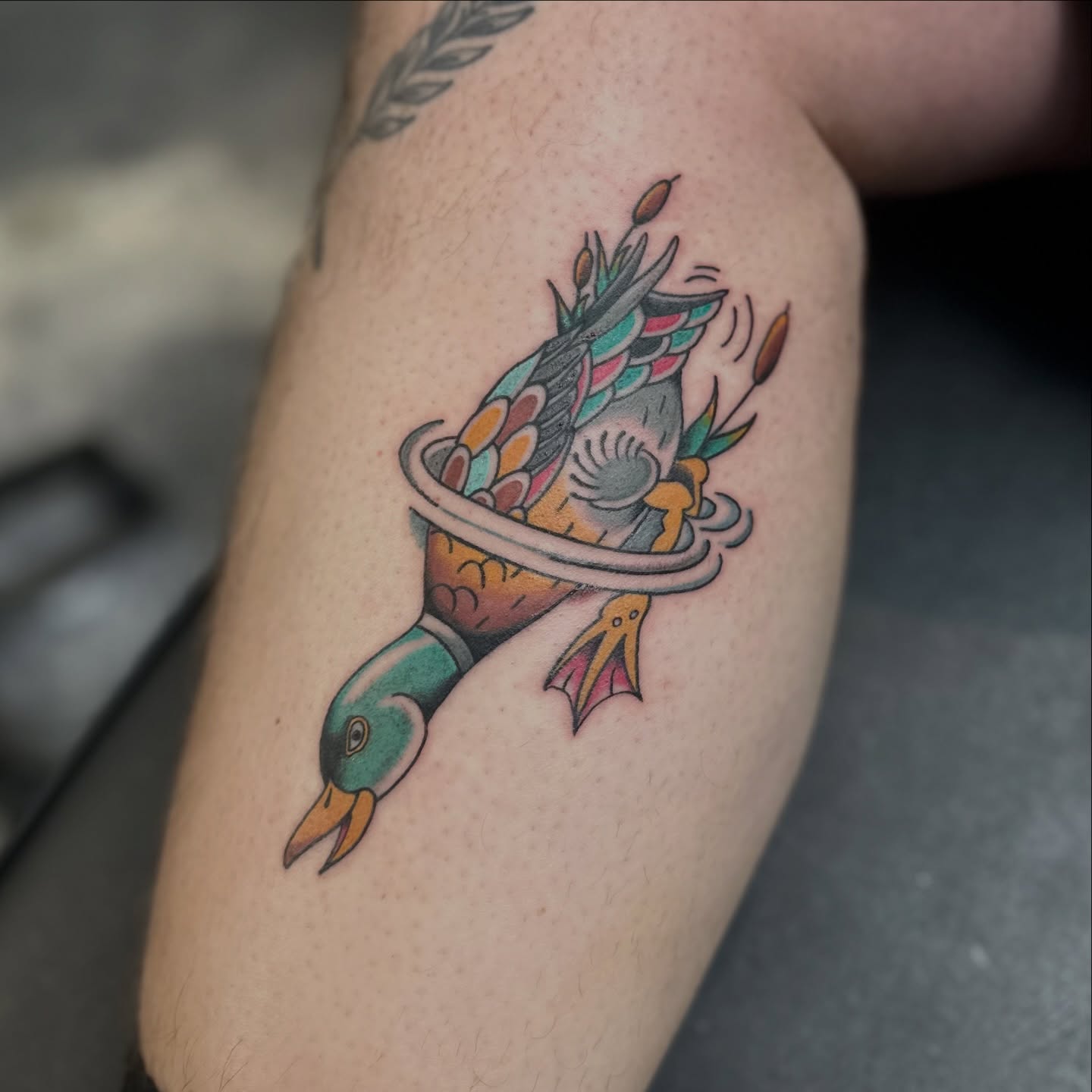Duck with hula hoop new school tattoo on the forearm by Nick Weaver aka gibby sometimes gilbert