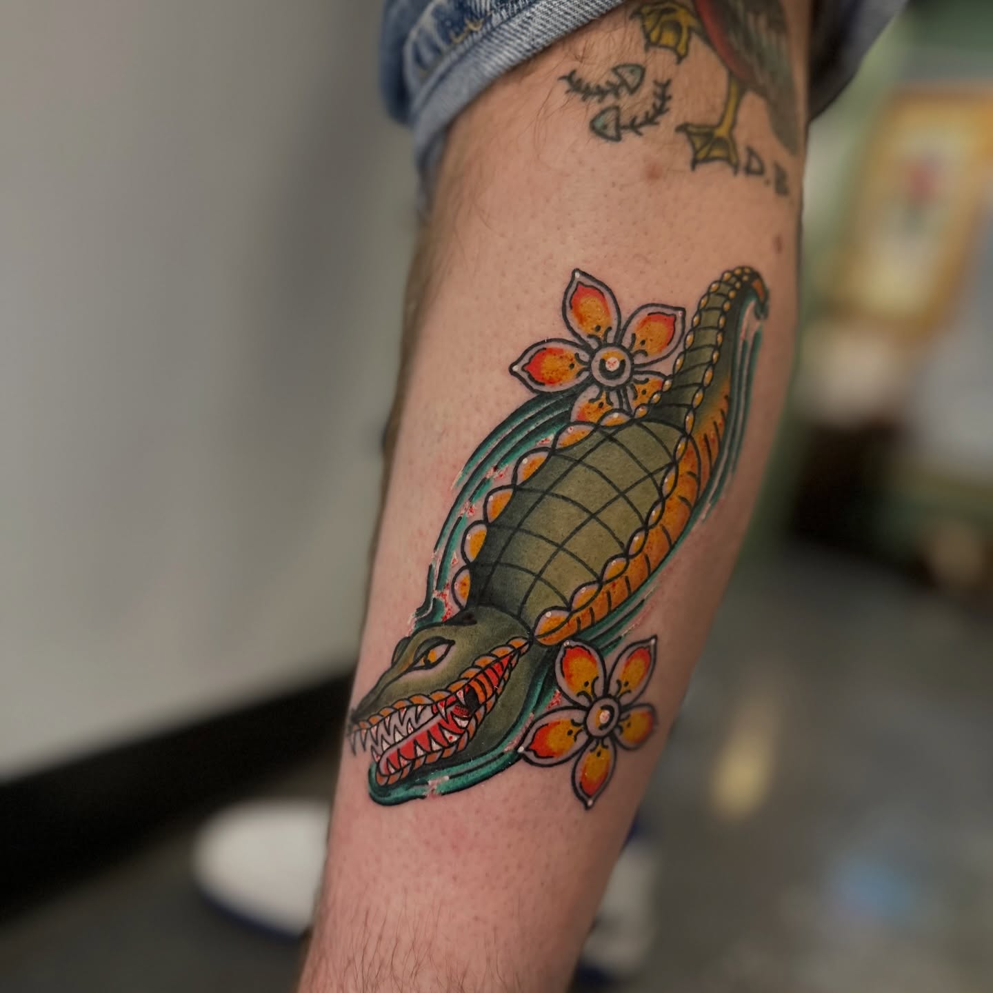 Alligator and flowers American traditional tattoo on the forearm by Nick Weaver aka gibby sometimes gilbert