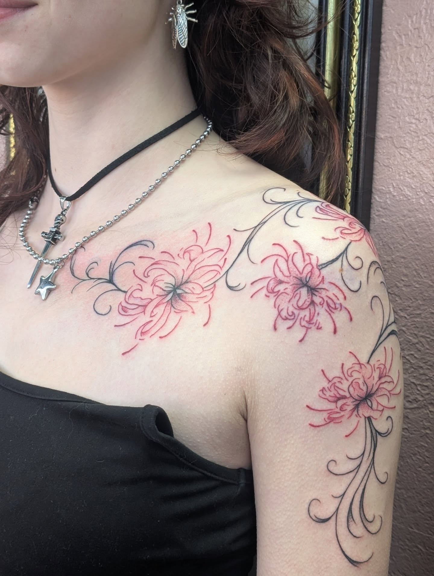 Chrysanthemums black and grey tattoo on the shoulder by Alexandria Green