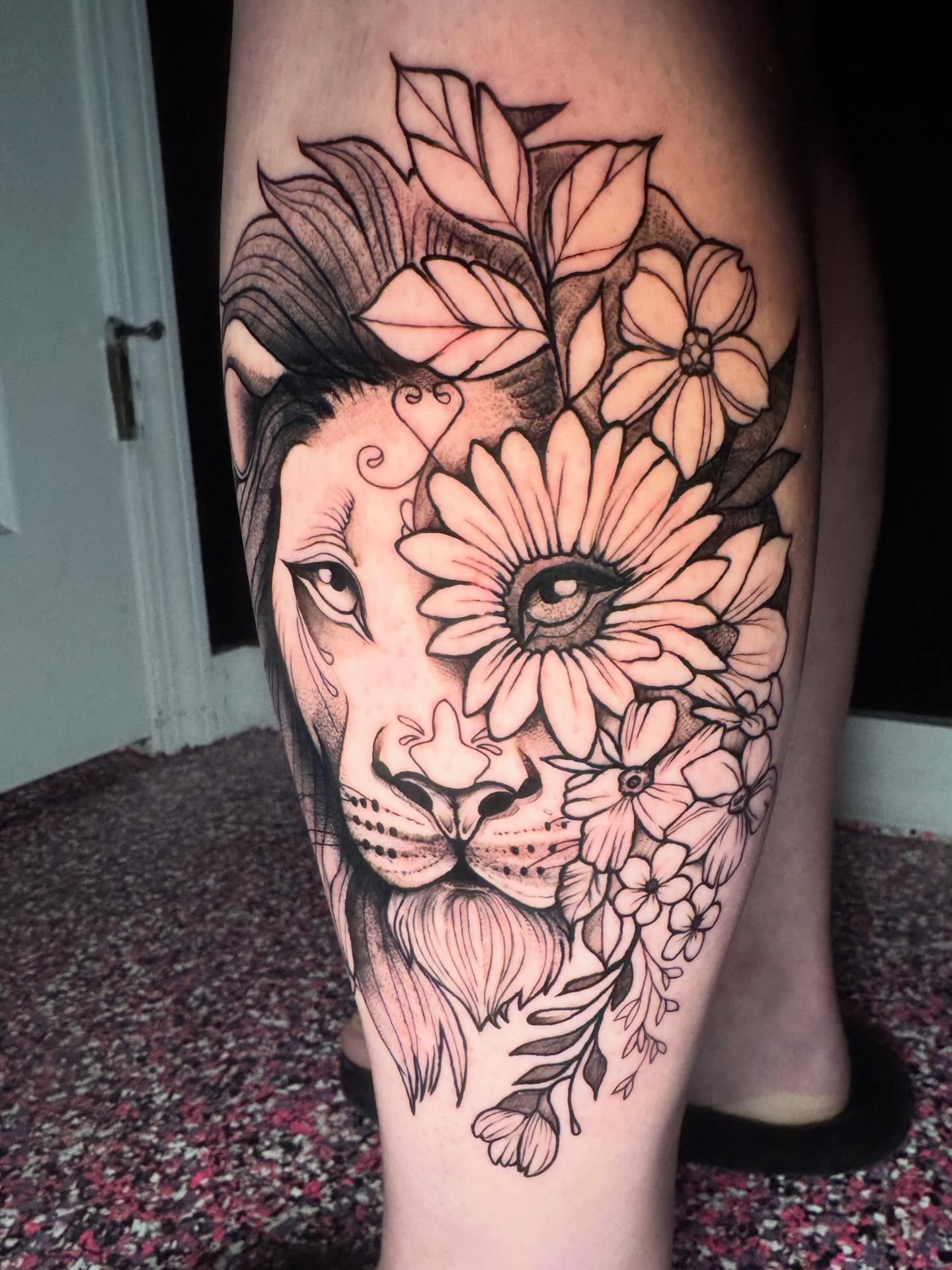 Lion and flowers realism tattoo on the thigh by Kayla Rosencrans