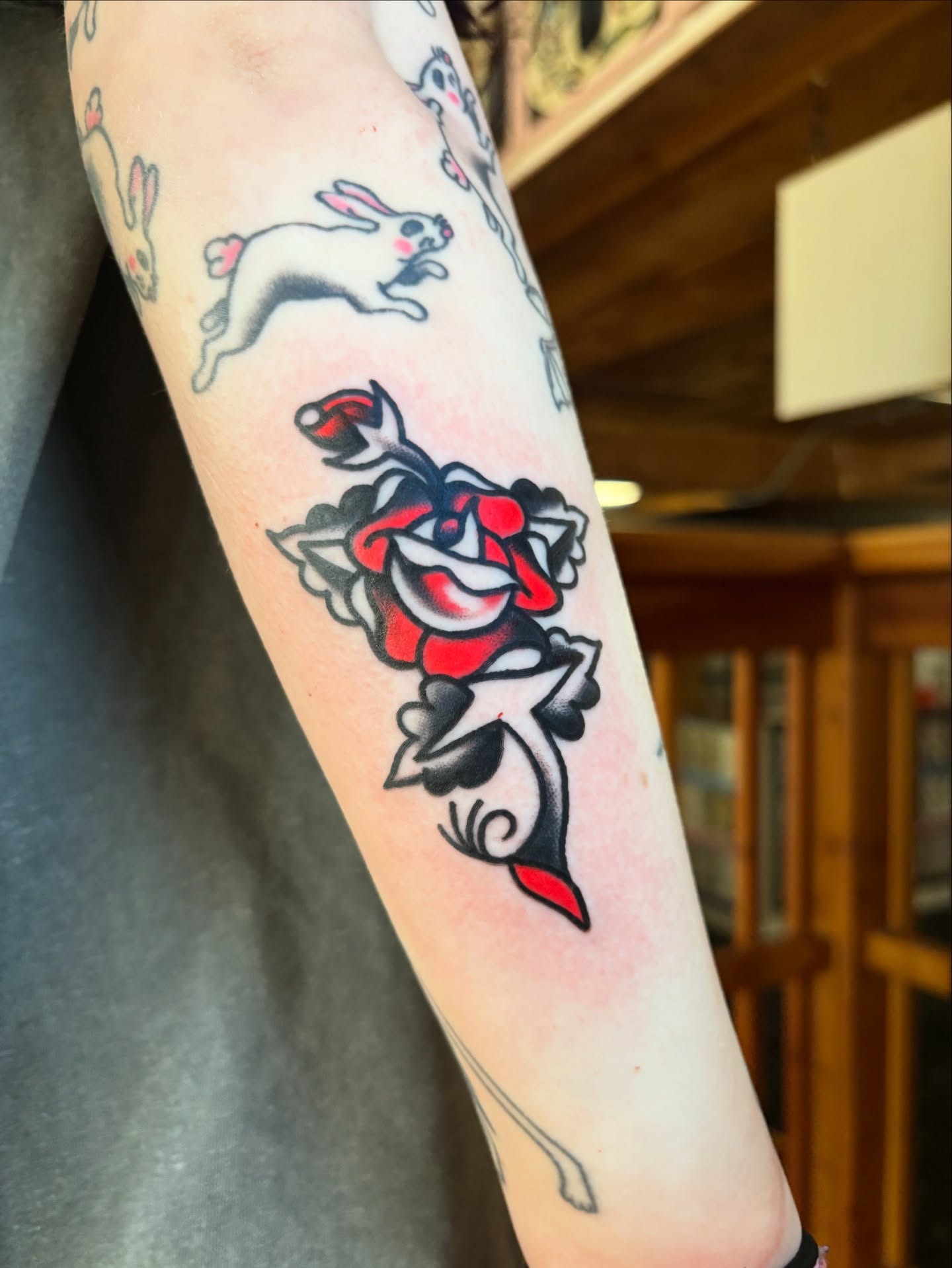 Rose American traditional tattoo on the forearm by Nick