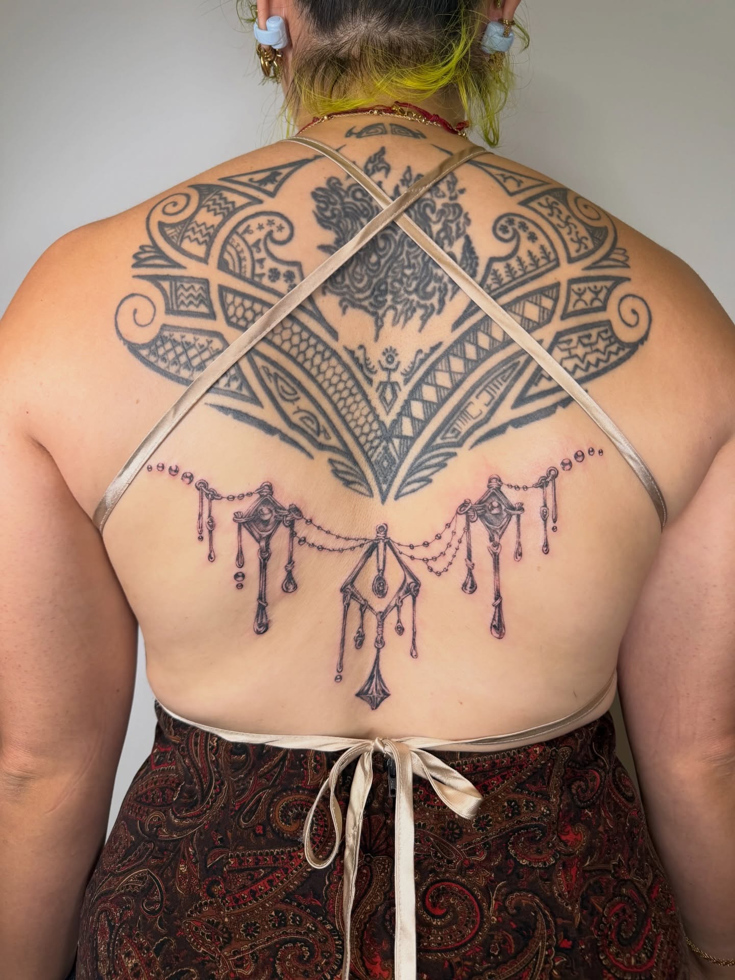 Tribal tribal tattoo on the back by Lauren ๐
