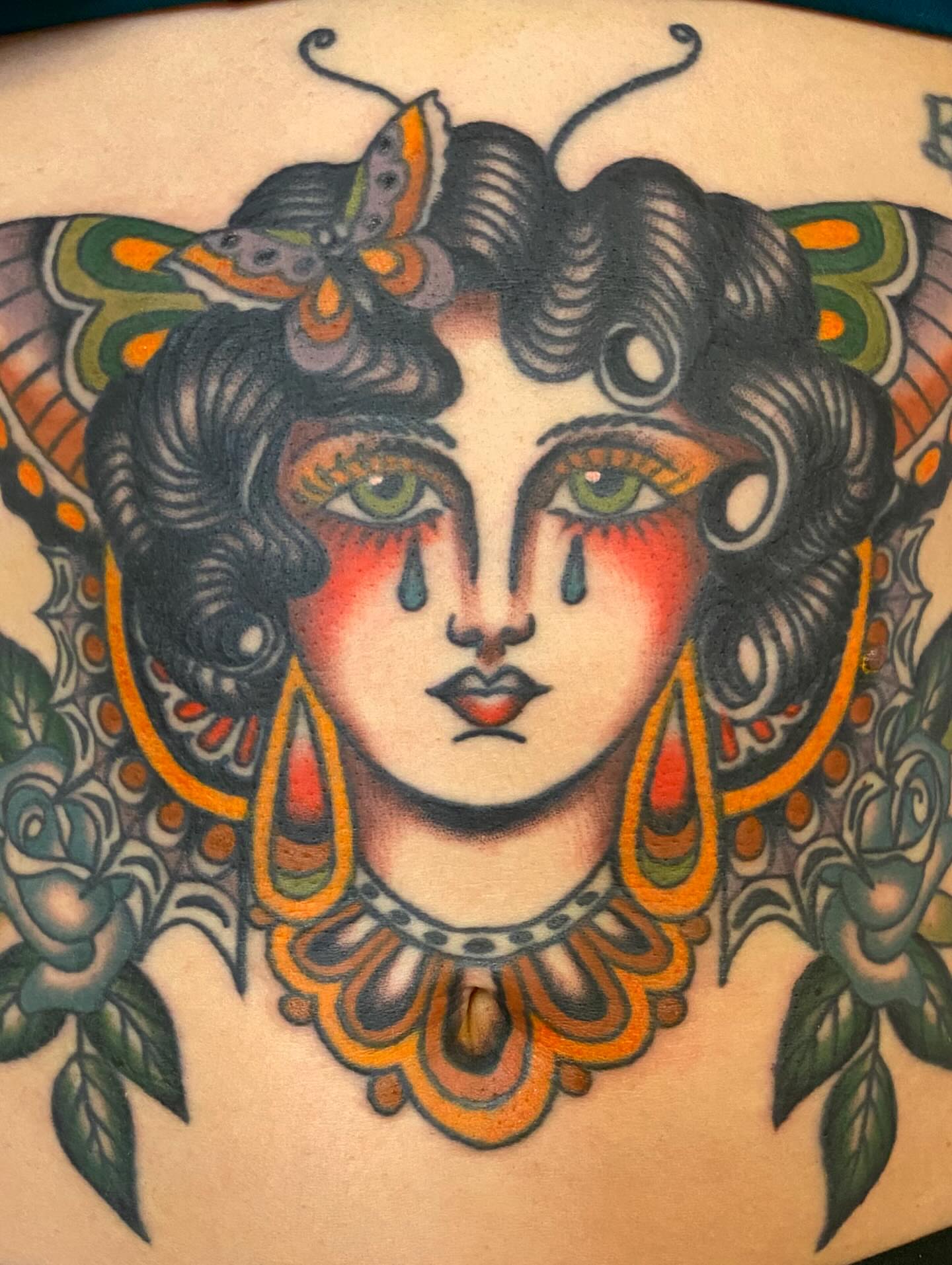 Woman with butterfly American traditional tattoo on the thigh by Kelsey Lane