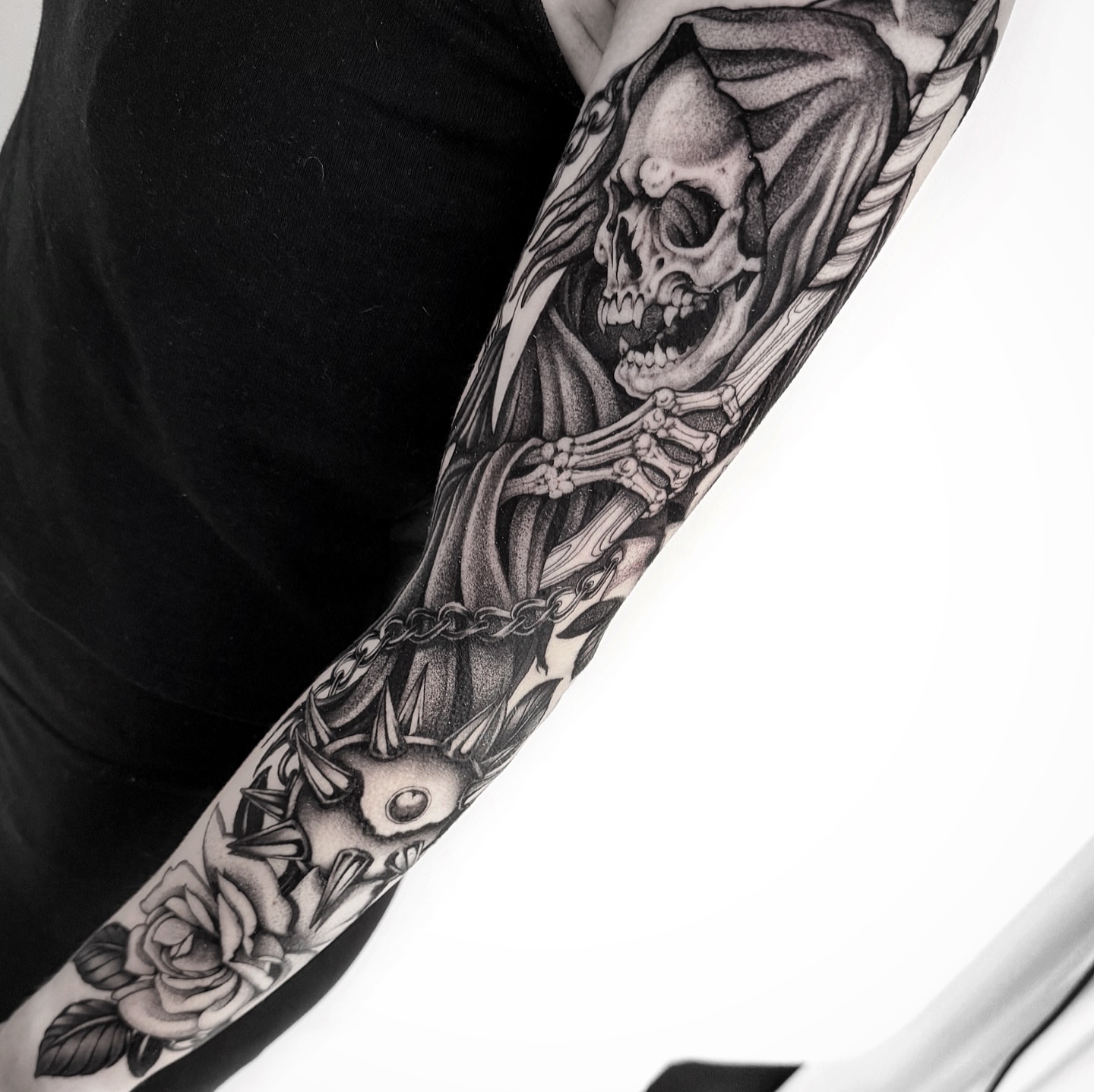 Grim reaper realism tattoo on the forearm by Tommy Sisneros