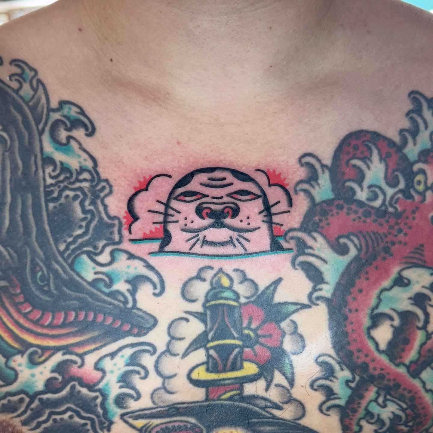 Cat head American traditional tattoo on the chest by Sam
