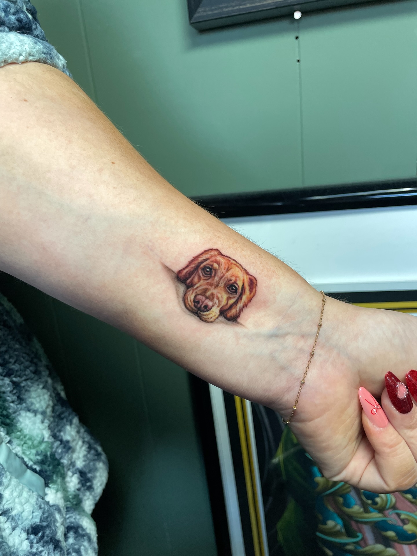 Dog realism tattoo on the forearm by Rick Elliott