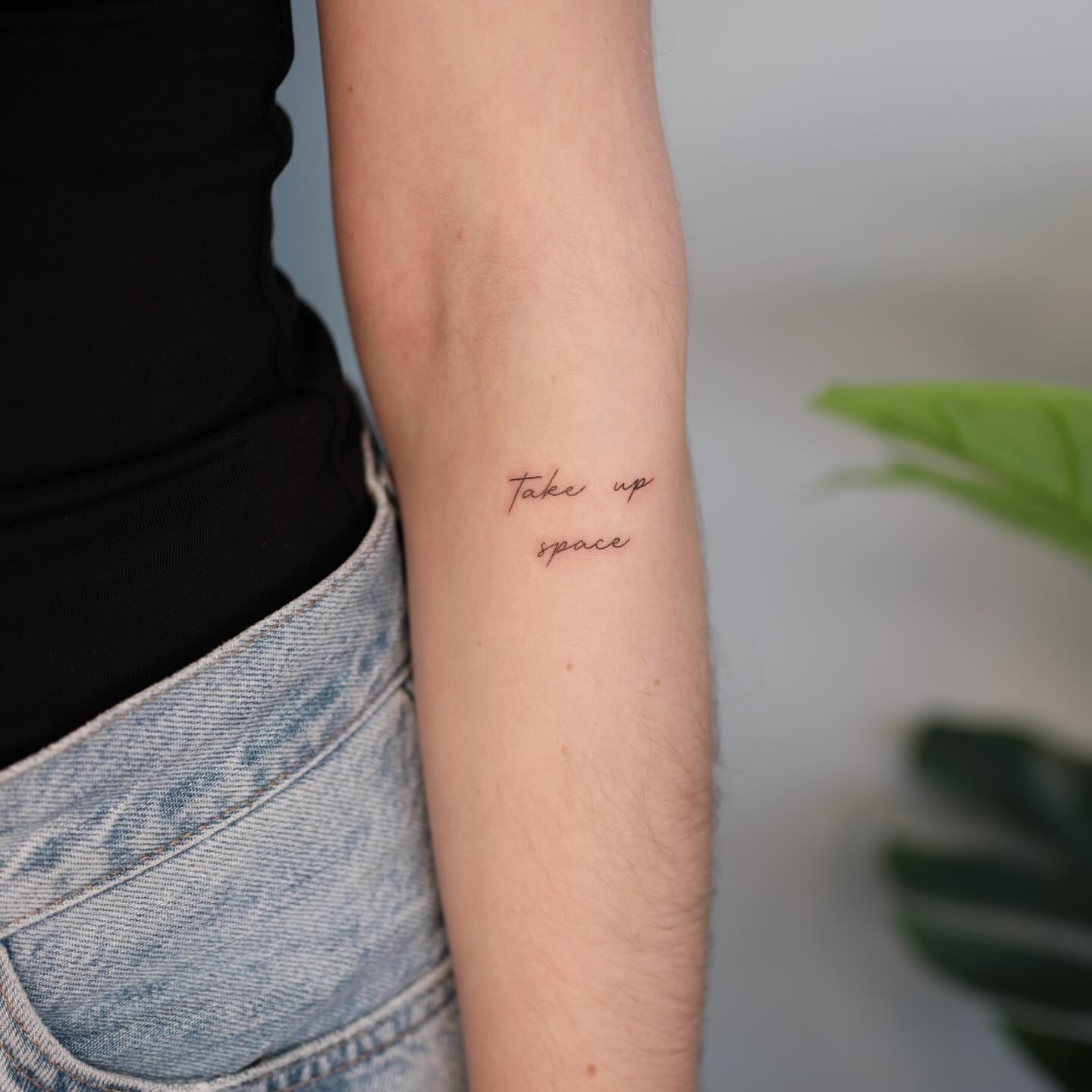 Take up space lettering script tattoo on the forearm by Nina