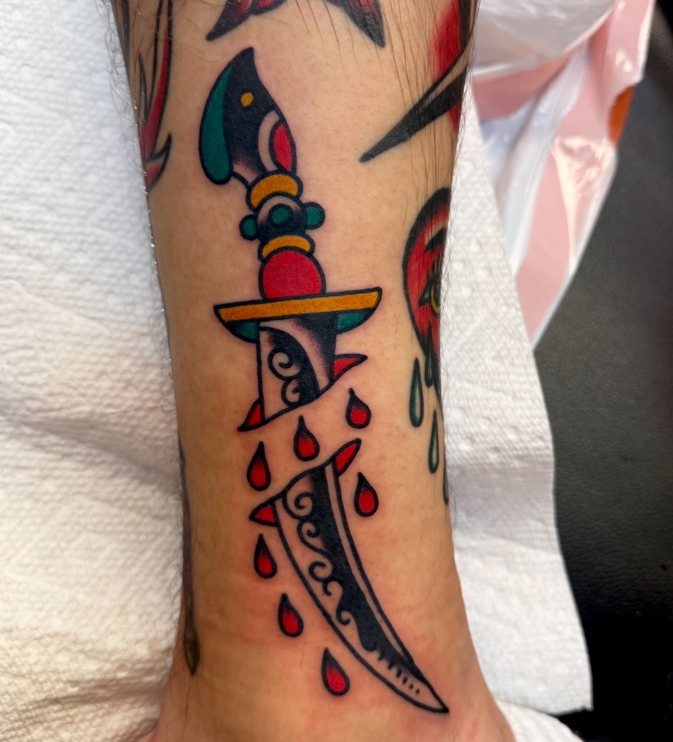 Knife and blood American traditional tattoo on the forearm by Buddy (Holiday) Orr, Las Vegas, Nevada