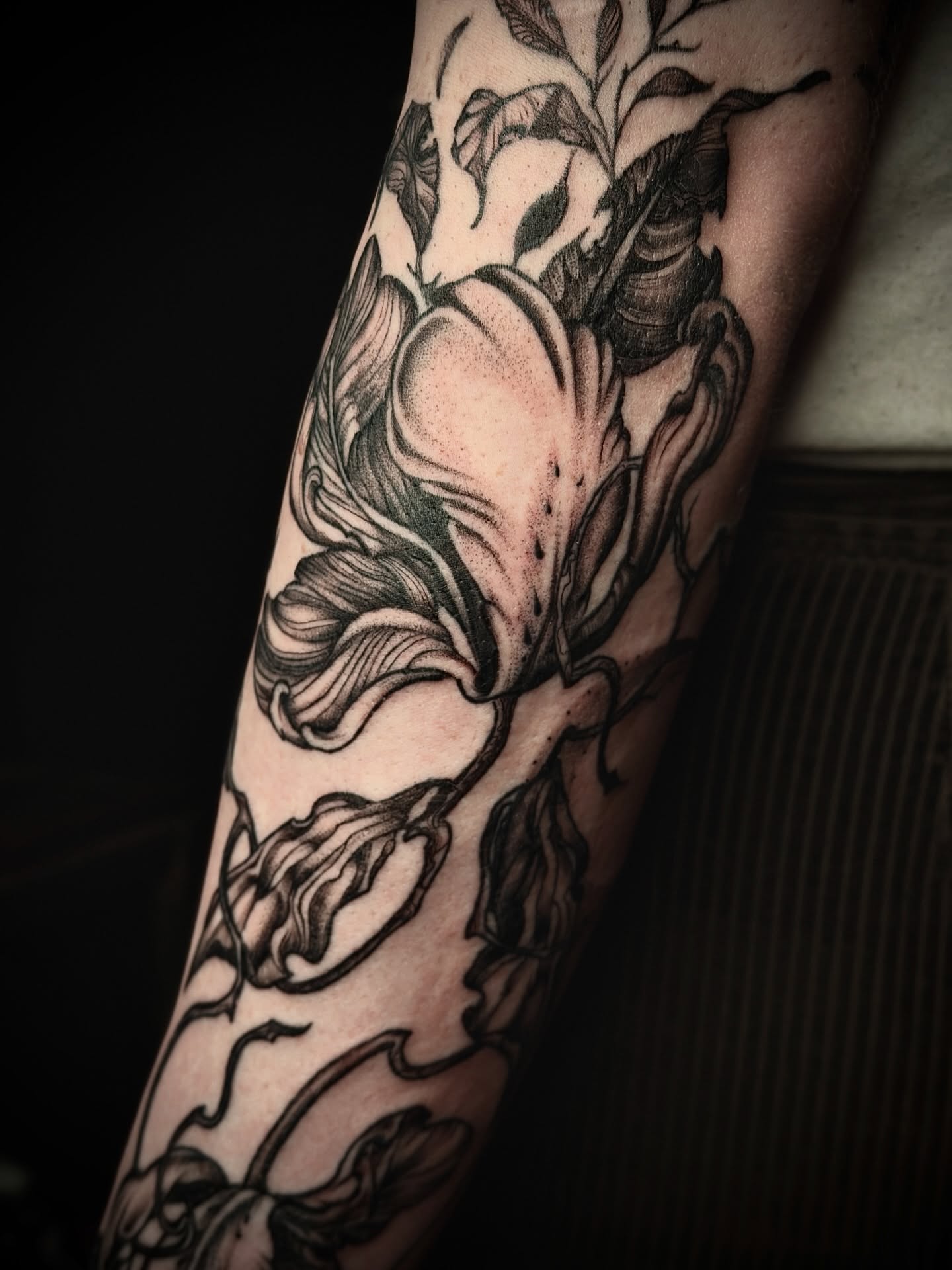Floral bouquet black and grey tattoo on the forearm by Giovanna Kline