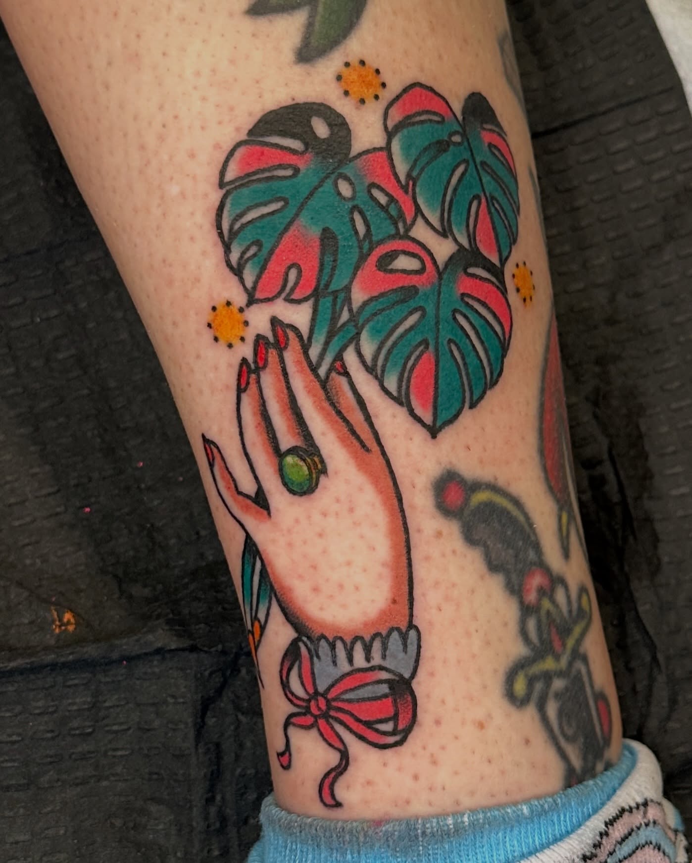Hand with monstera leaves American traditional tattoo on the forearm by Paige Ochoa