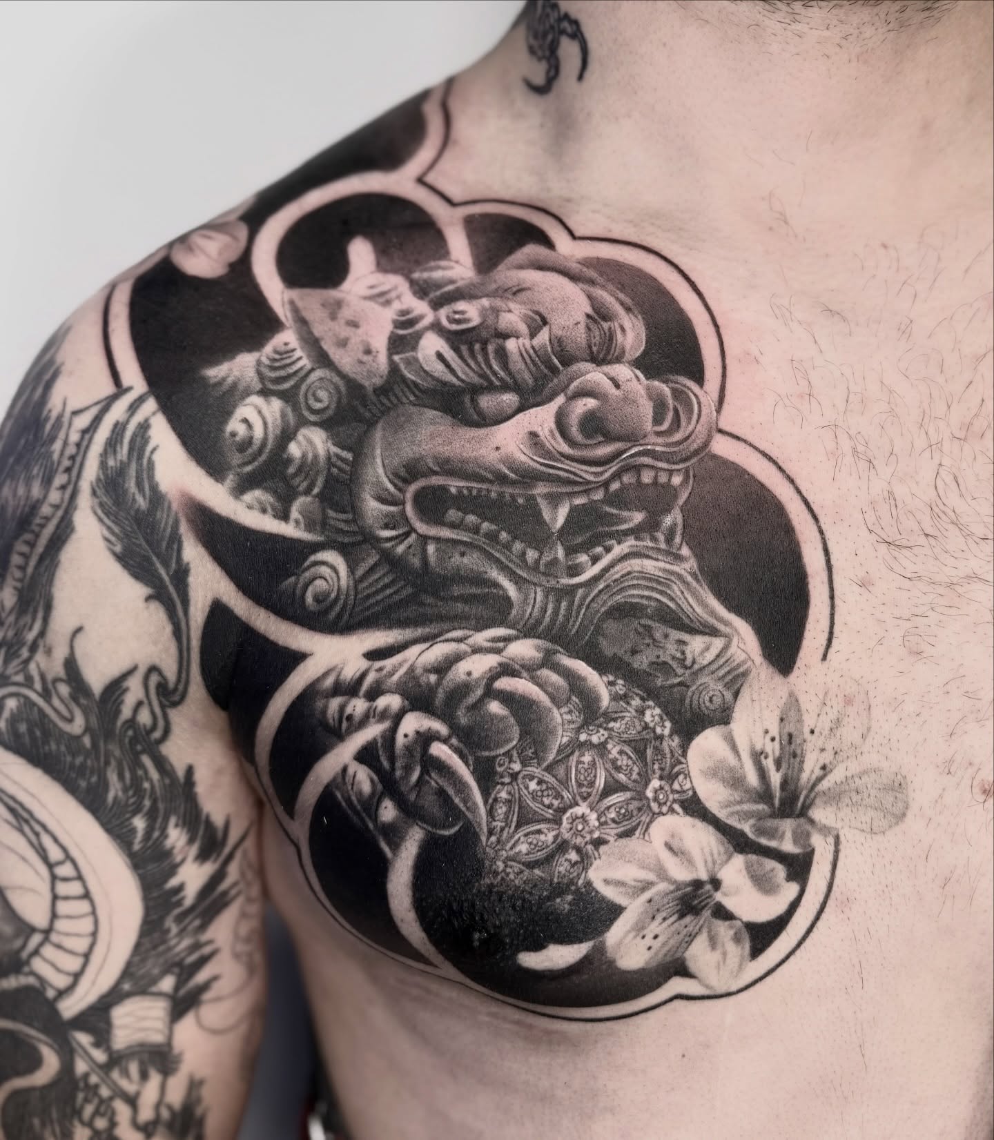 Lion and flowers realism tattoo on the chest by Abrianna