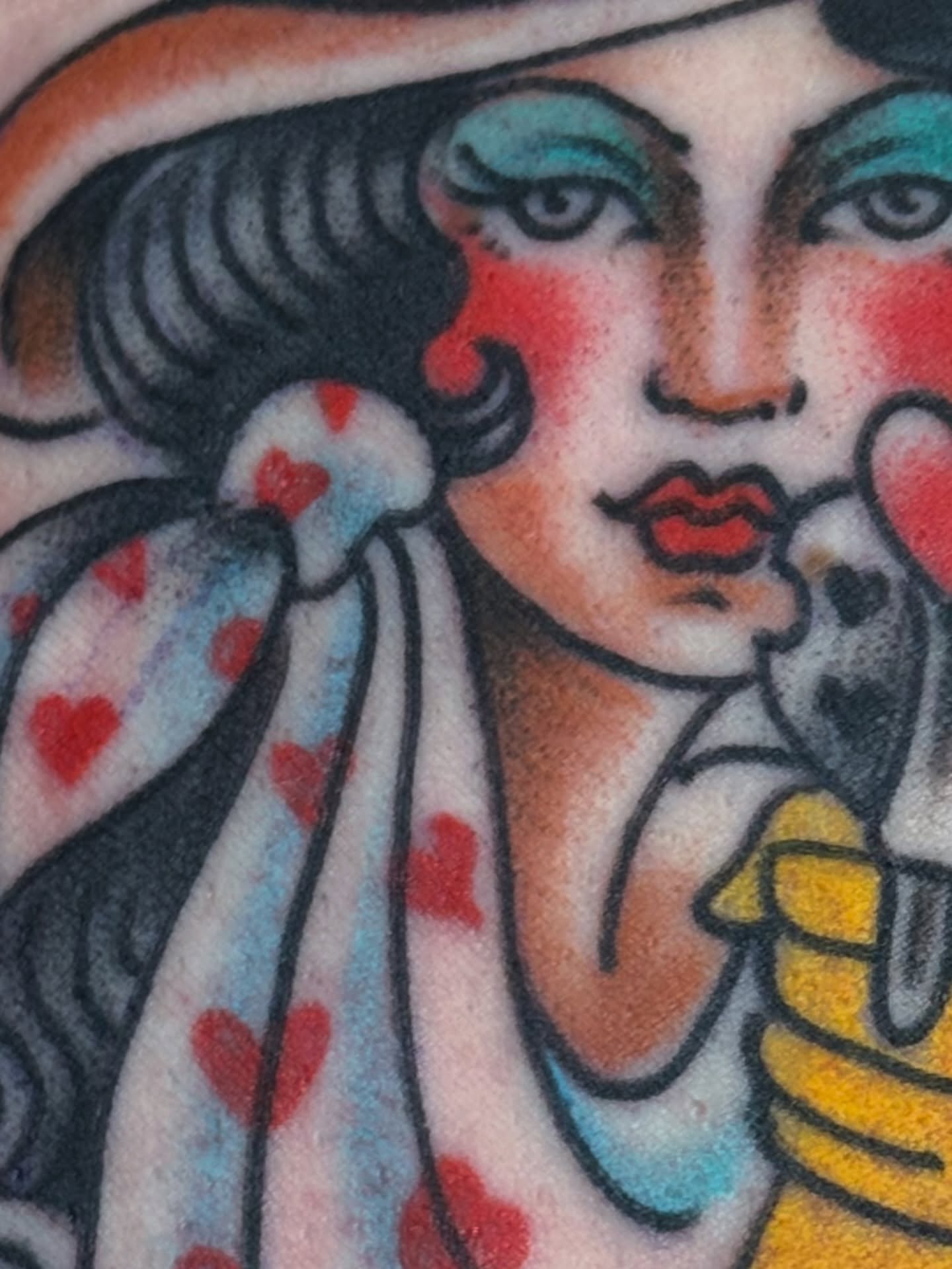 Woman with heart pattern American traditional tattoo on the upper arm by Ben Karnofsky