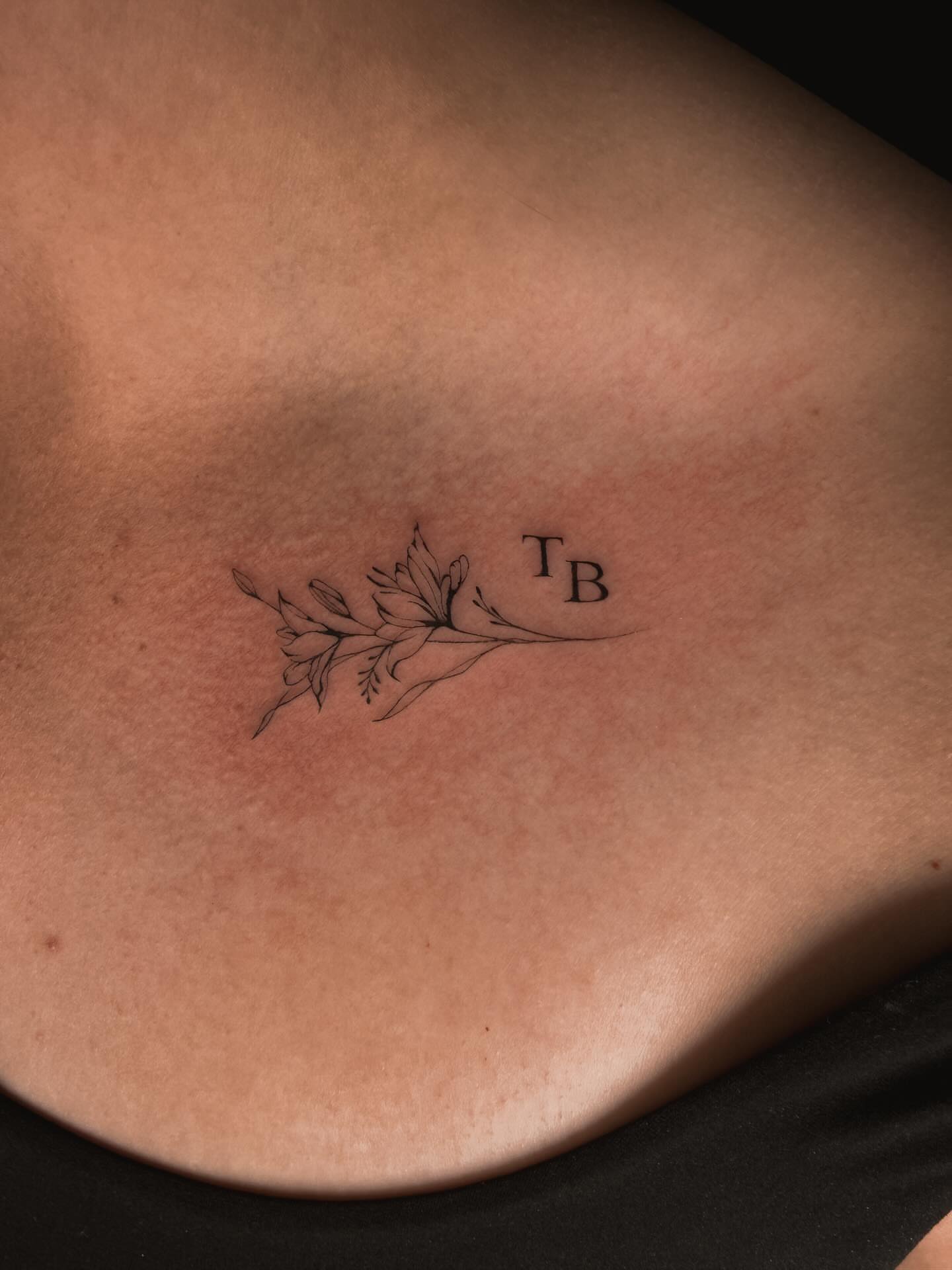 Flower and initials black and grey tattoo on the chest by π»ππ π
ππππ Tattoo Artist, Las Vegas, Nevada