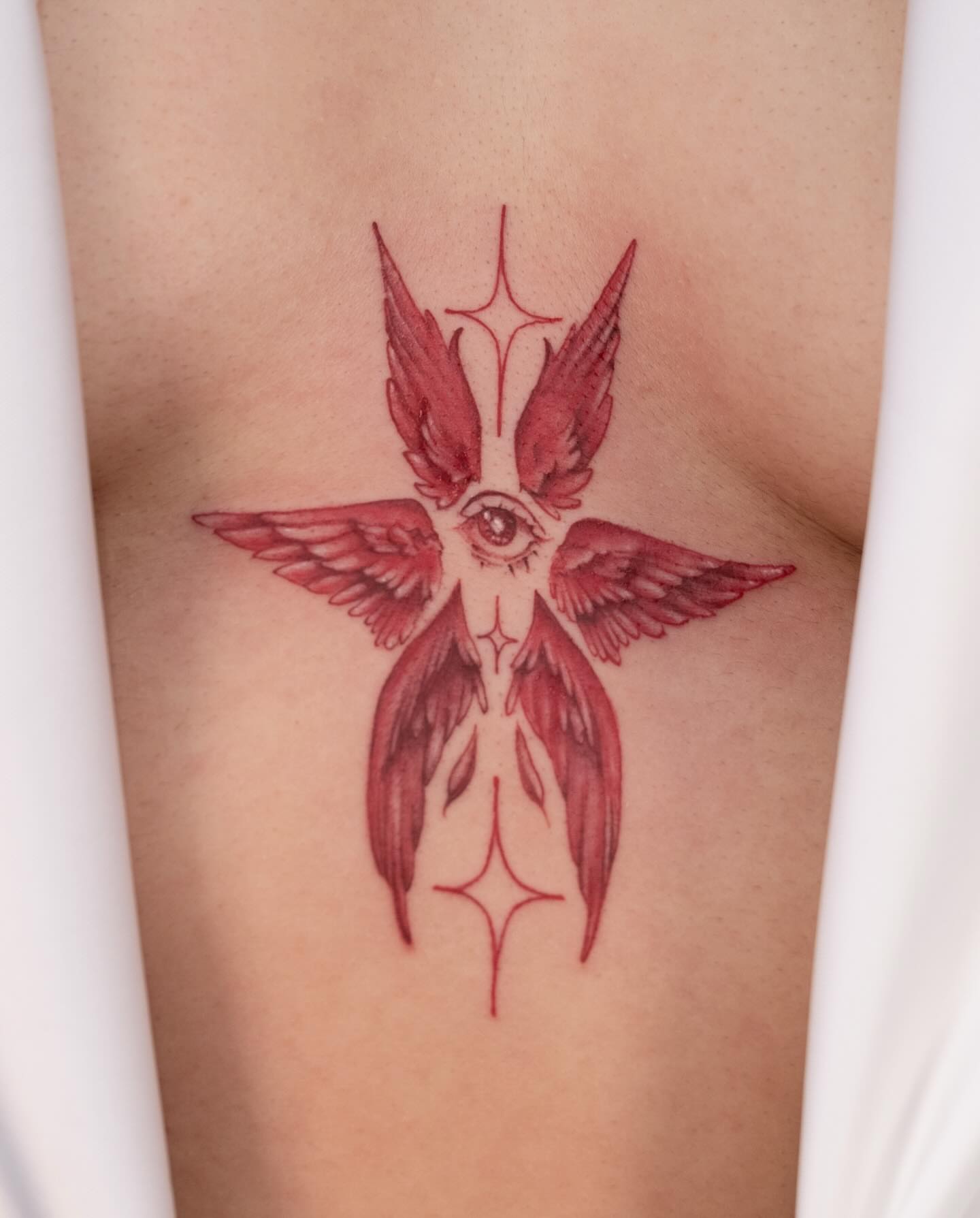 Eye with wings geometric tattoo on the thigh by Koko