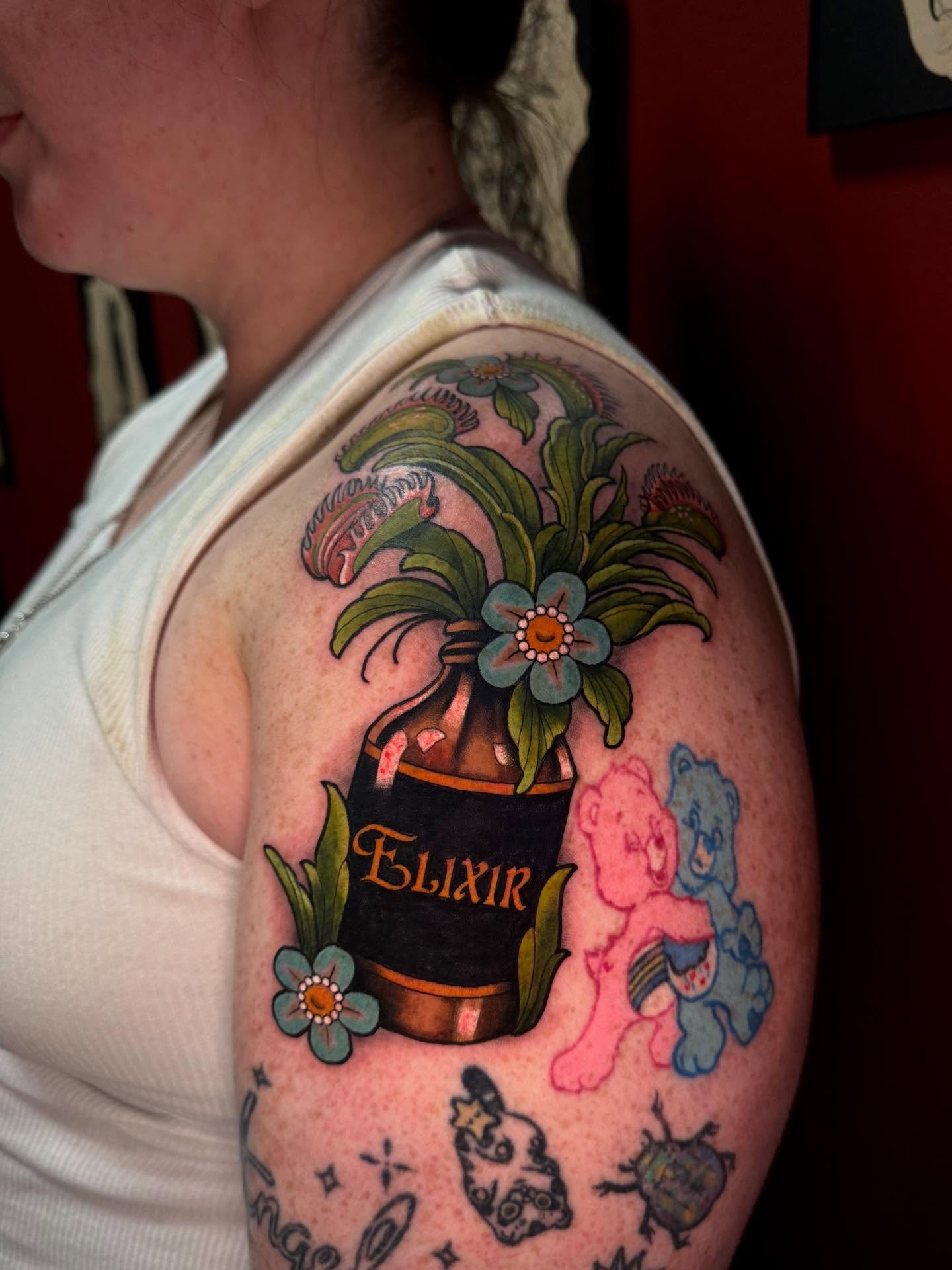 Care bears and elixir bottle new school tattoo on the shoulder by Penny - Tattooer