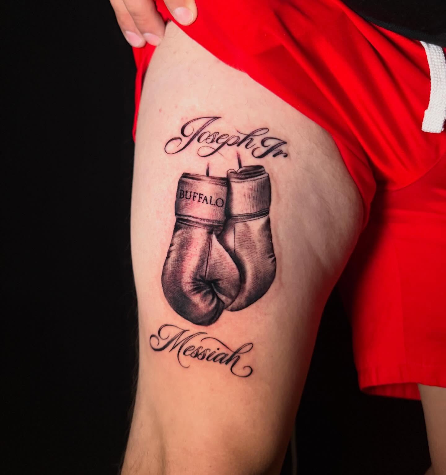 Boxing gloves black and grey tattoo on the thigh by George Maldonado Austin, Austin, Texas