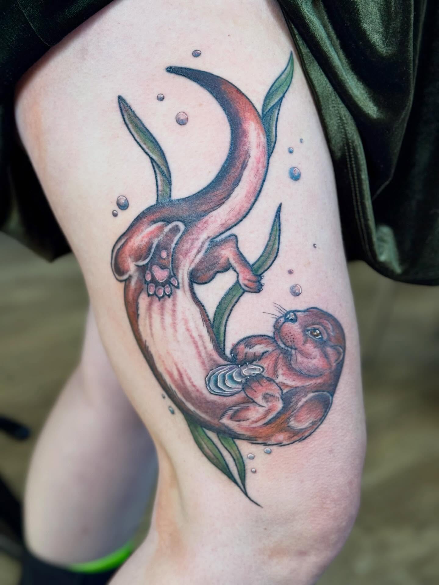 Otter and octopus realism tattoo on the thigh by @carissaetattoos