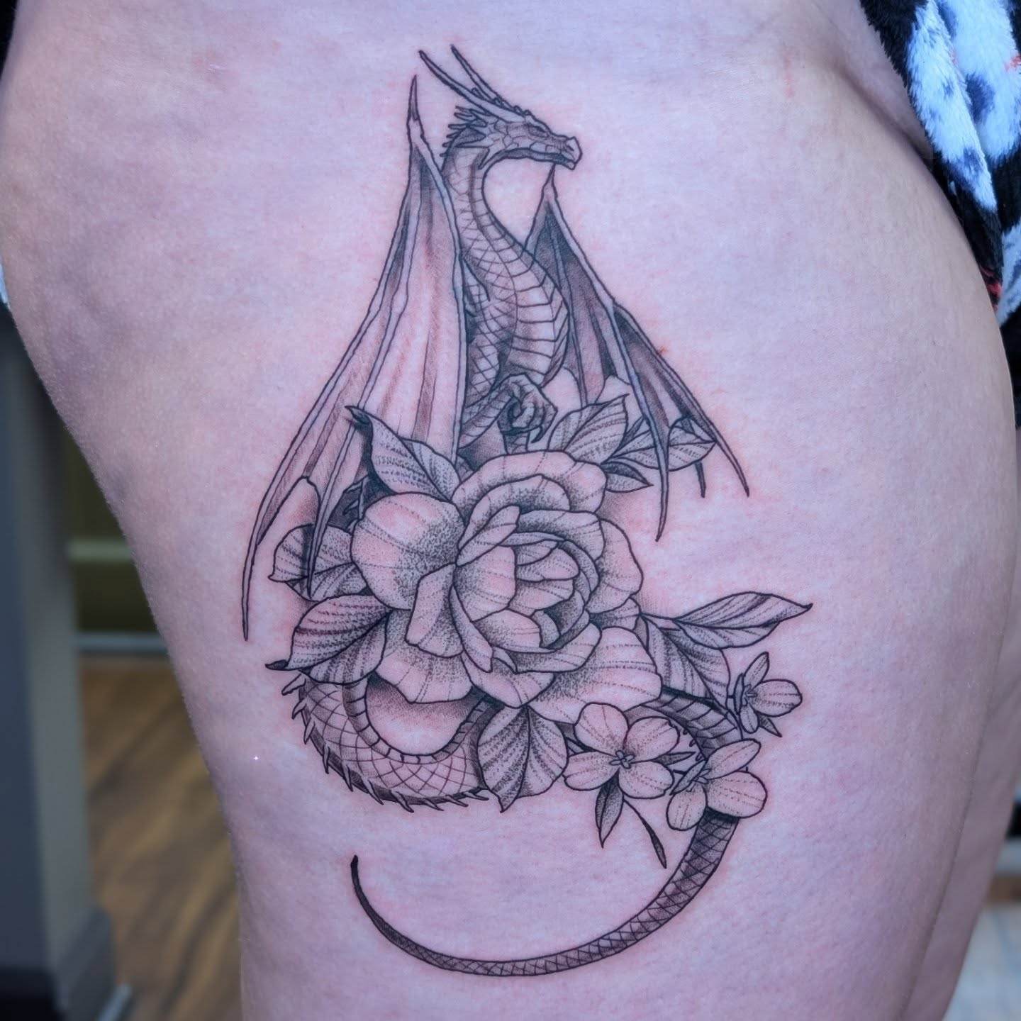 Dragon and rose dotwork tattoo on the thigh by Will Alexander, Lombard, Illinois