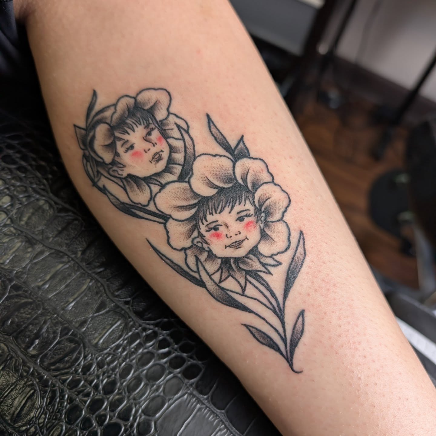 Children in flowers realism tattoo on the forearm by Will Alexander, Lombard, Illinois