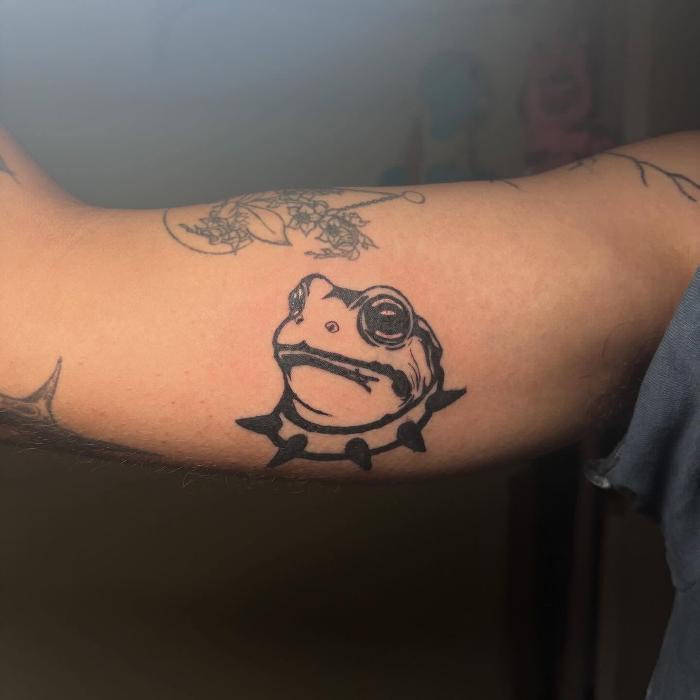 Frog black and grey tattoo on the forearm by Shampooh