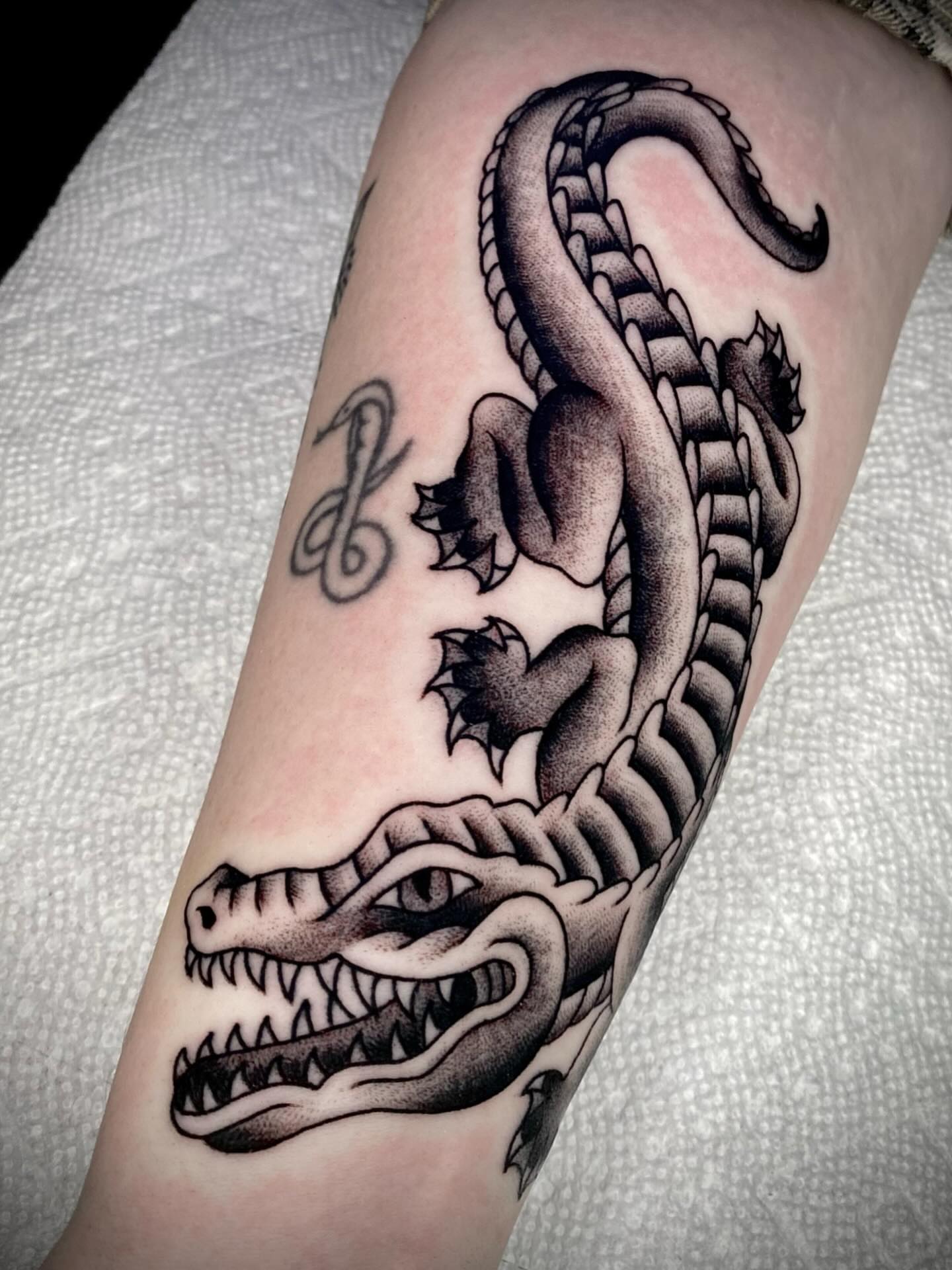 Dragon black and grey tattoo on the forearm by Zach Knisley (Wiz)