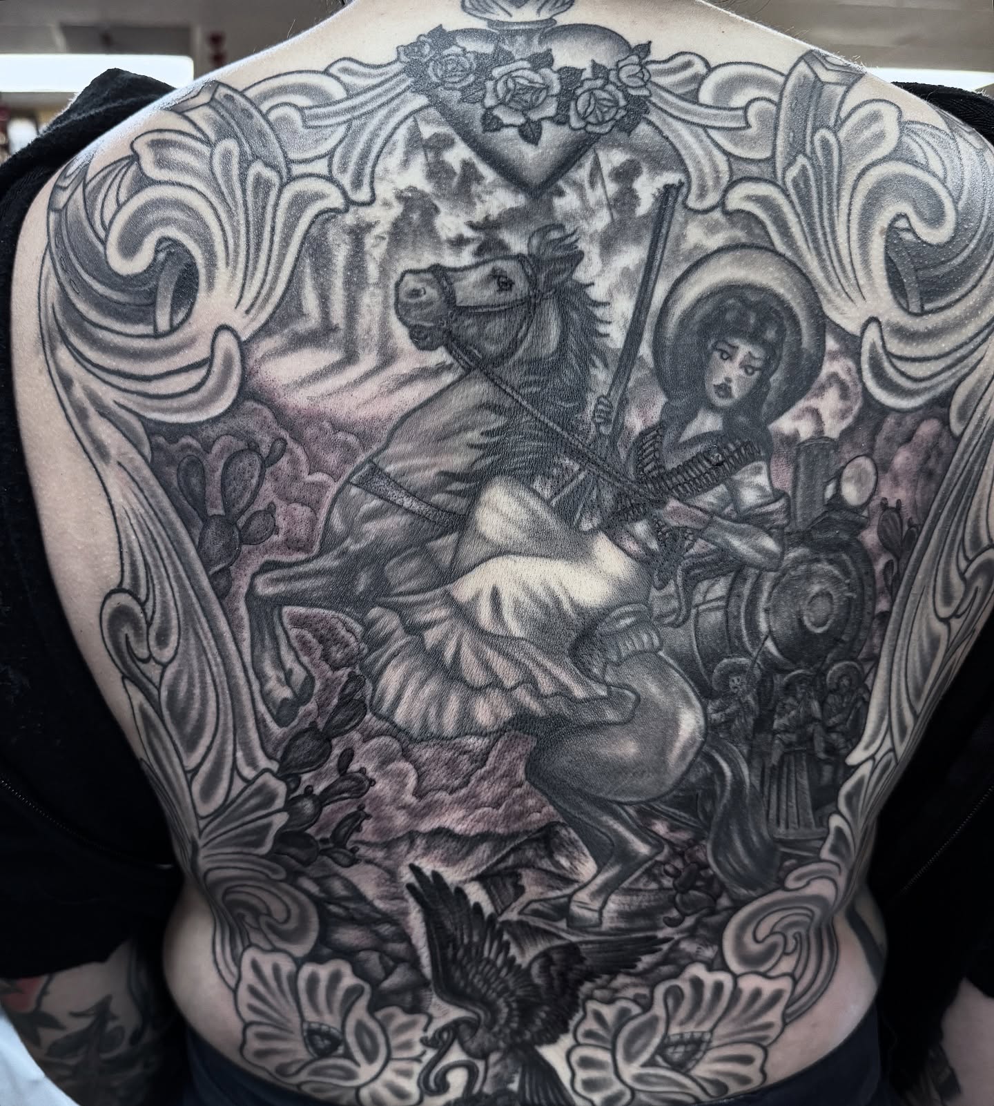 Saint george slaying dragon realism tattoo on the back by Lisa Del Toro