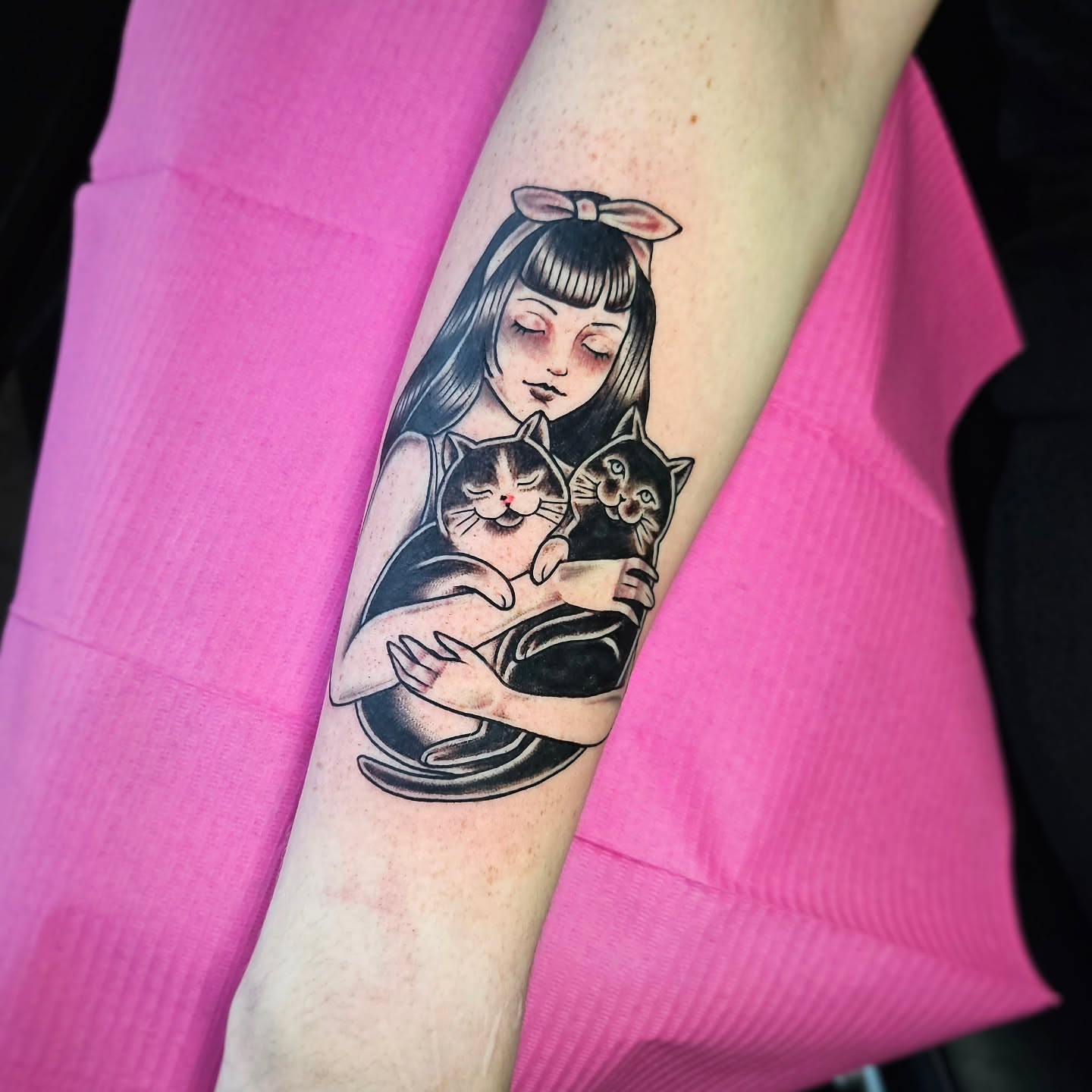 Girl with cats anime tattoo on the forearm by Monaca Patterson