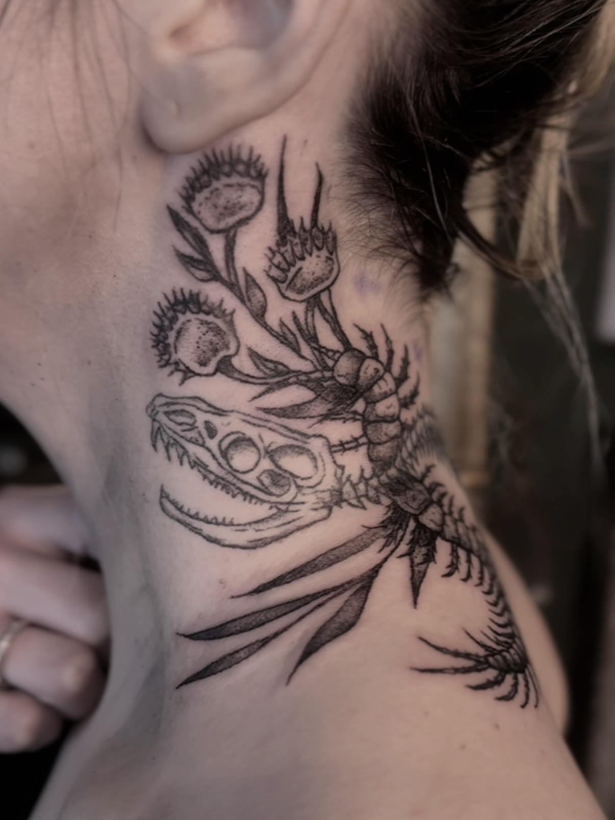 Dinosaur skull and flowers realism tattoo on the neck by Tattoo Artist, Philadelphia, Pennsylvania