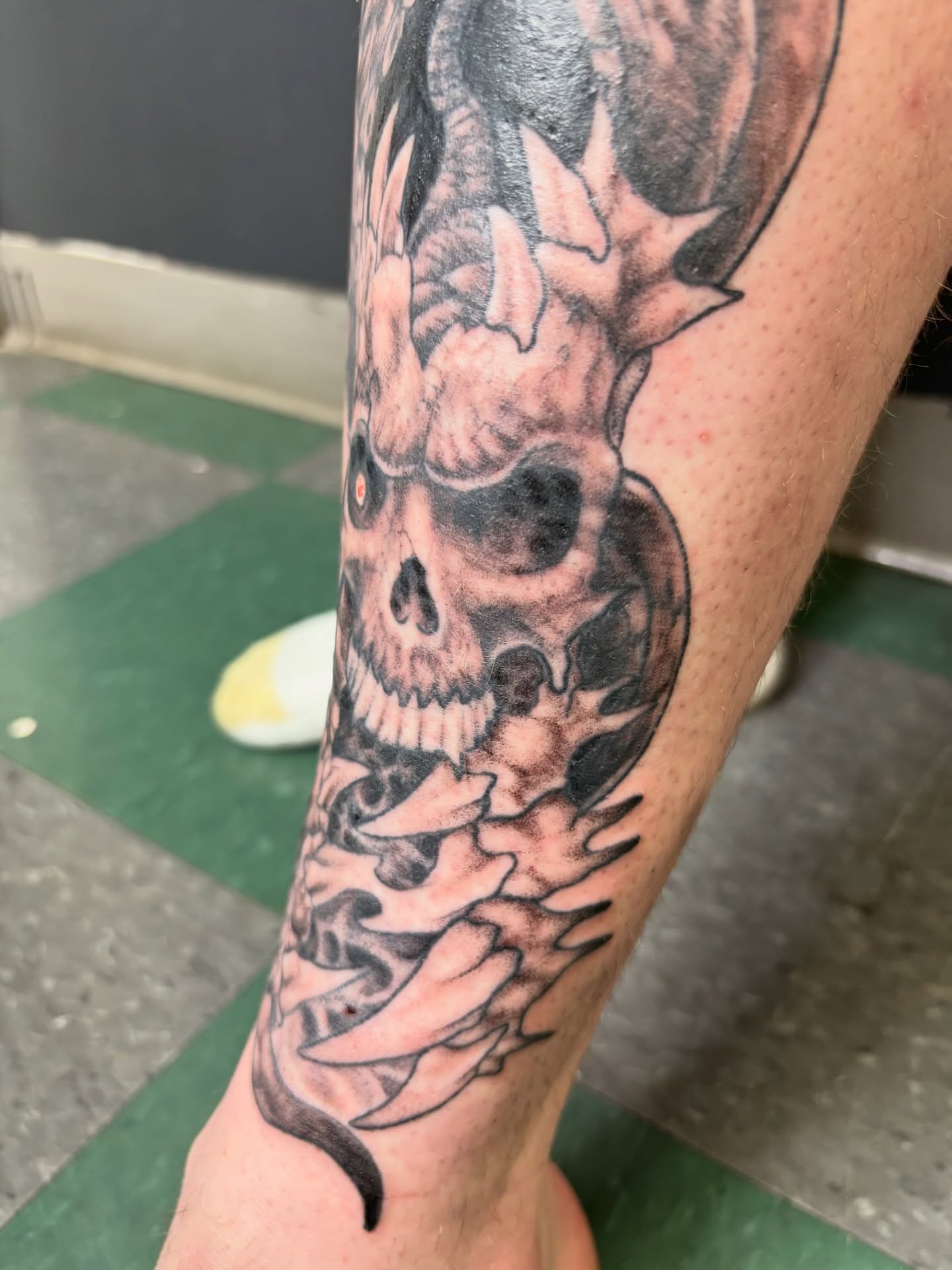 Flaming skull realism tattoo on the forearm by Noah Blum