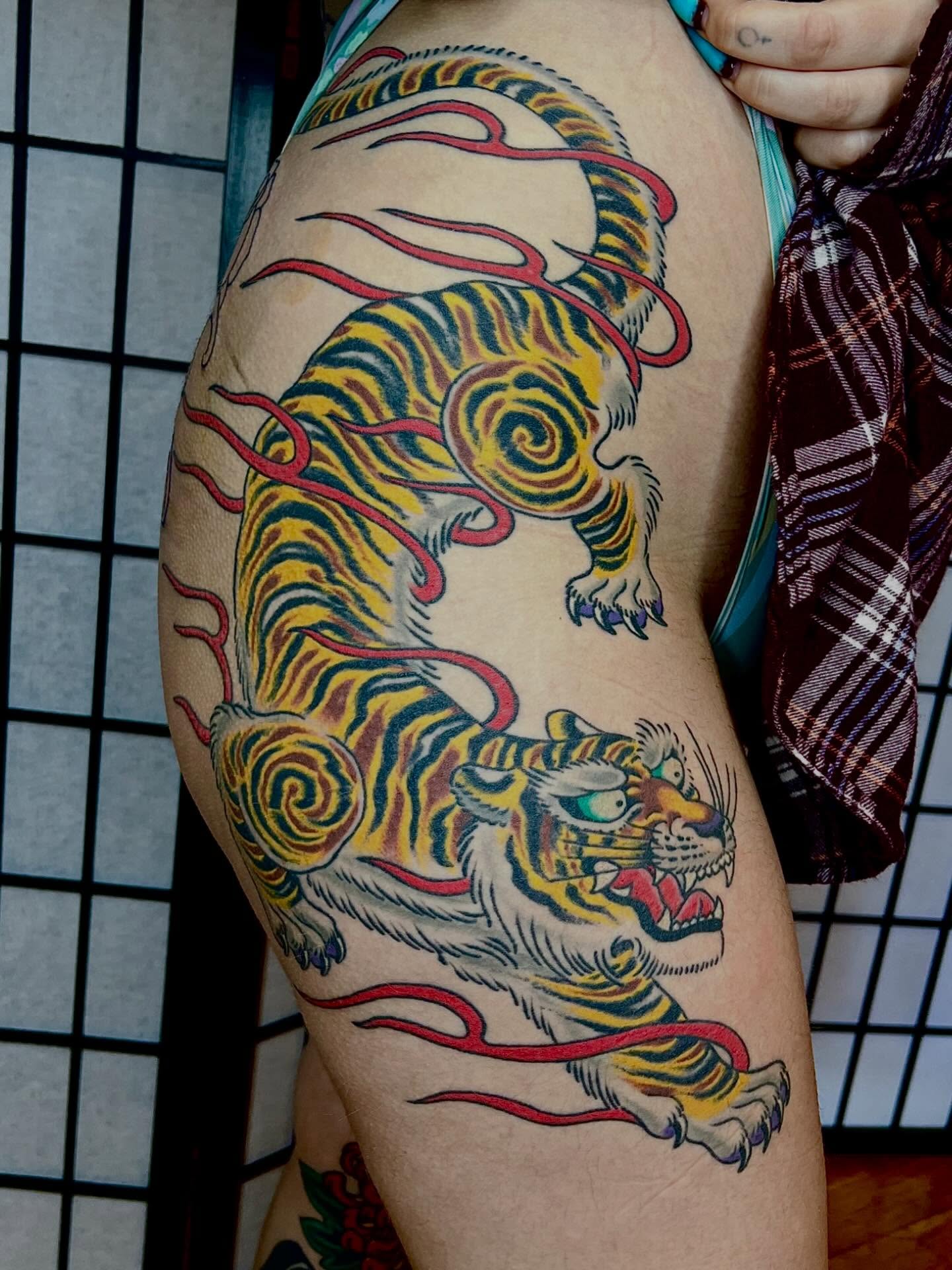 Tiger American traditional tattoo on the thigh by Graham Niles
