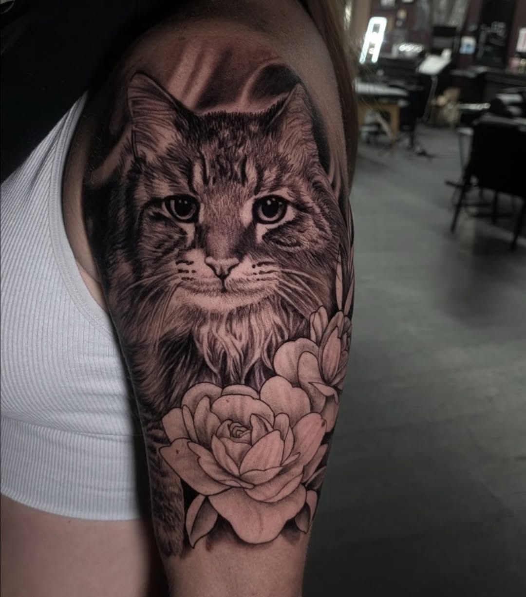Cat and roses realism tattoo on the forearm by Joe Shepp