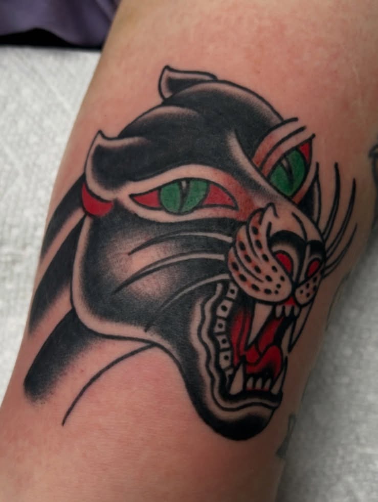 Panther American traditional tattoo on the thigh by Tiffany Vargas
