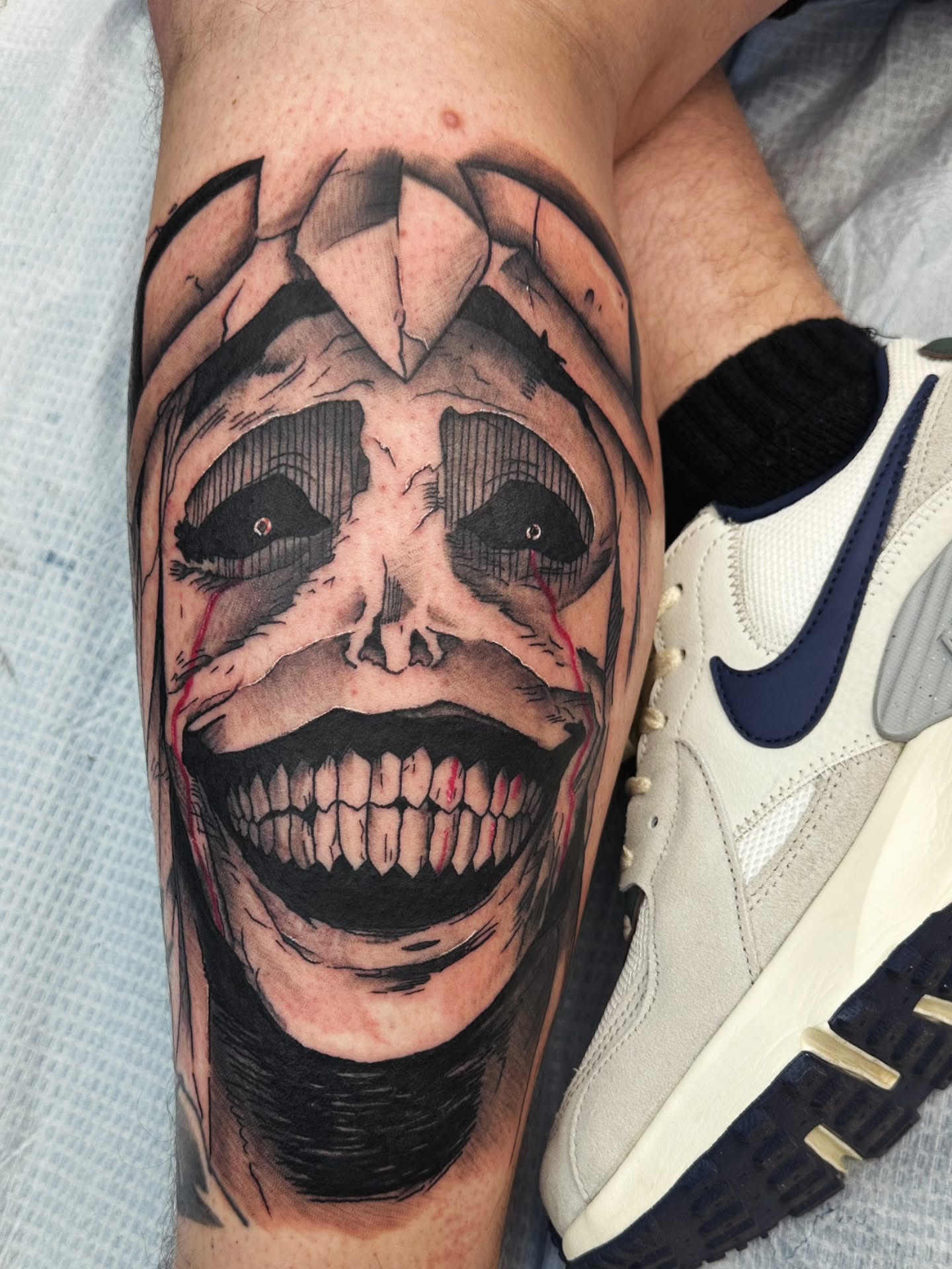 Grinning skull dark realism tattoo on the forearm by Cody Gower Tattoo Artist