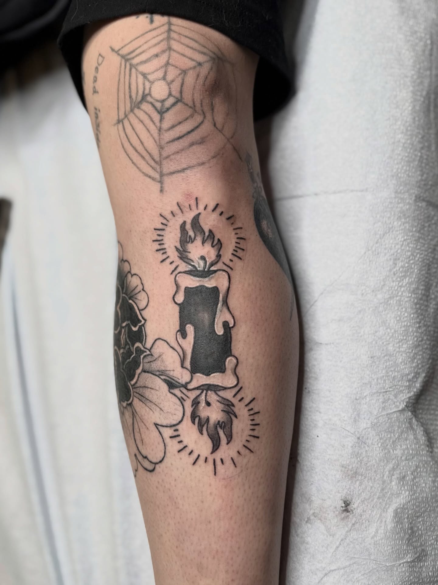 Candle and flower black and grey tattoo on the forearm by Kelsey Lynn▪️Raleigh Tattoo Artist