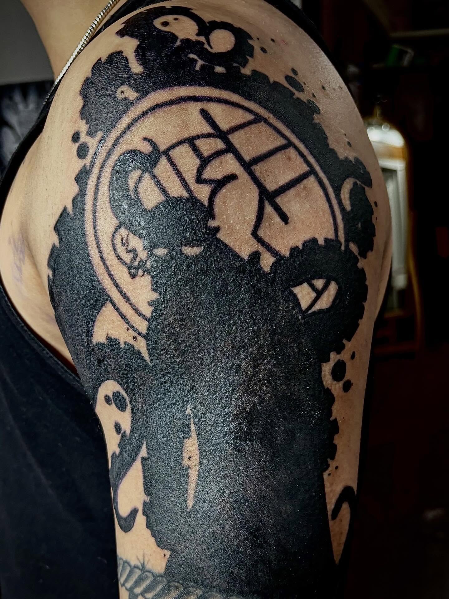 Ram and symbol black and grey tattoo on the shoulder by Rayne