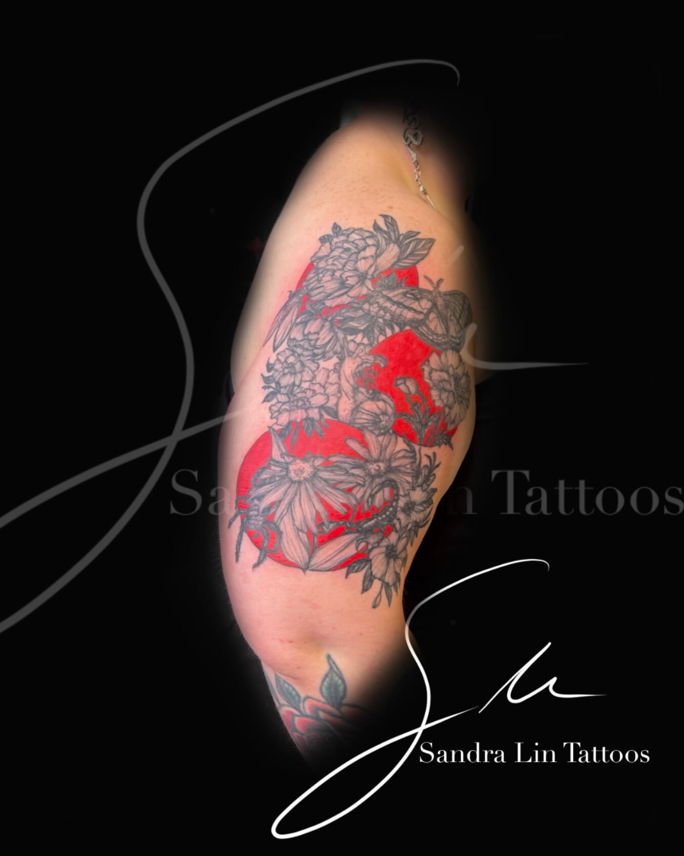 Floral bouquet black and grey tattoo on the upper arm by Sandra Lin Cue