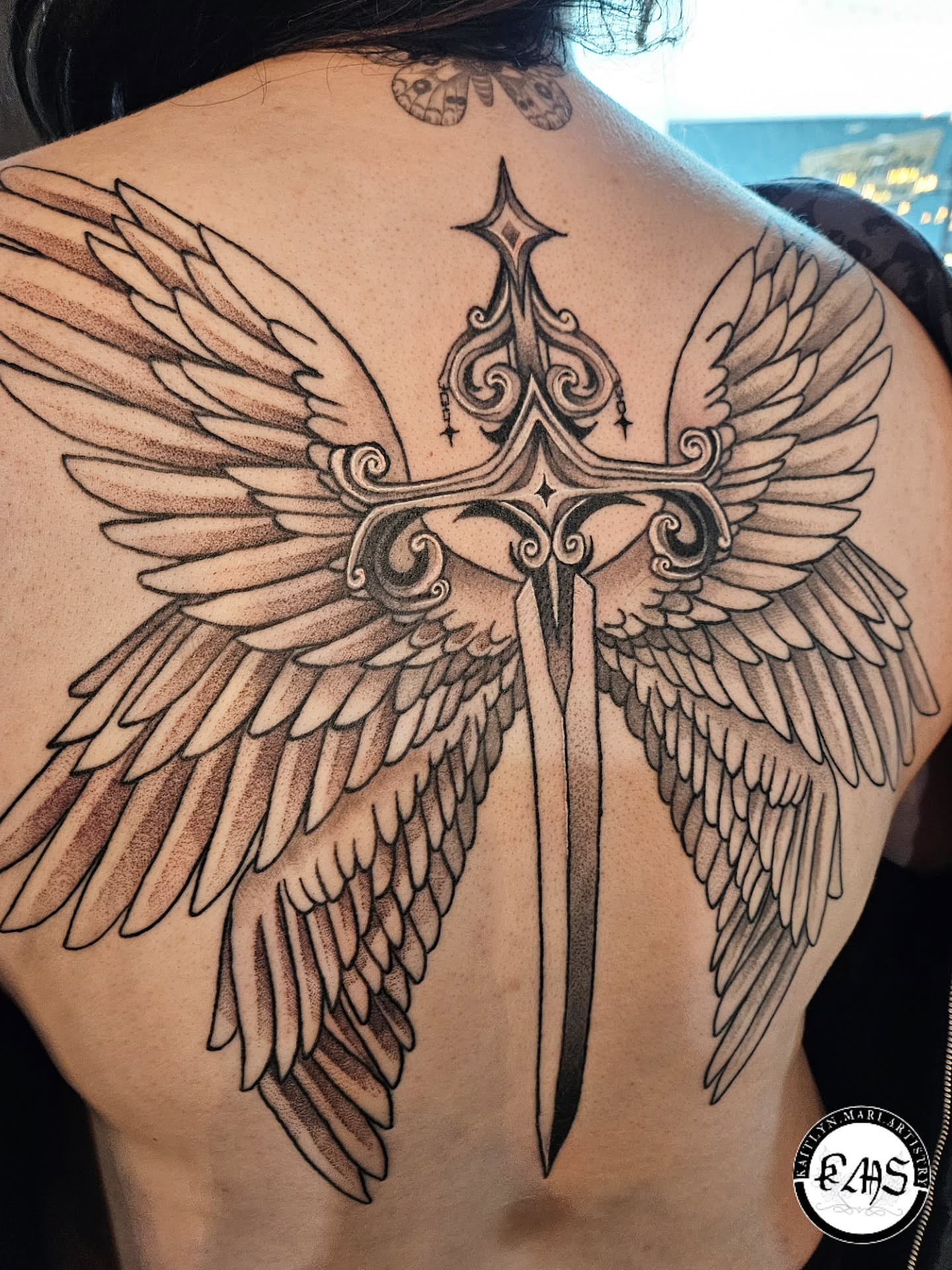 Wings and sword black and grey tattoo on the back by Kaitlyn Marianna Skewes 🌙 Illustrative
