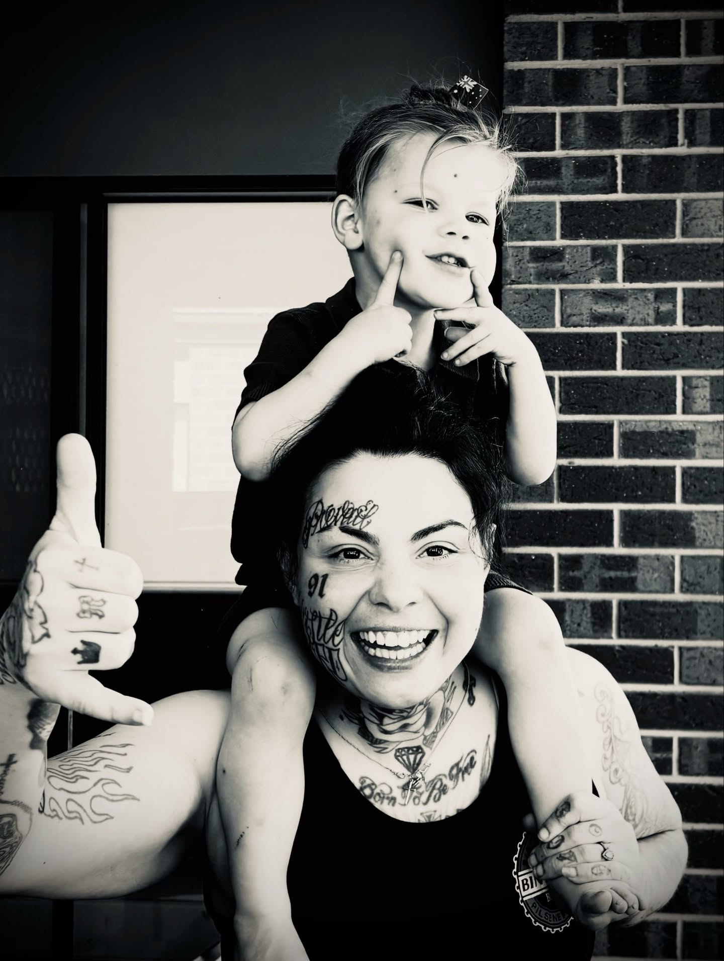 Tattooed woman with child black and grey tattoo on the torso by @tatt2st