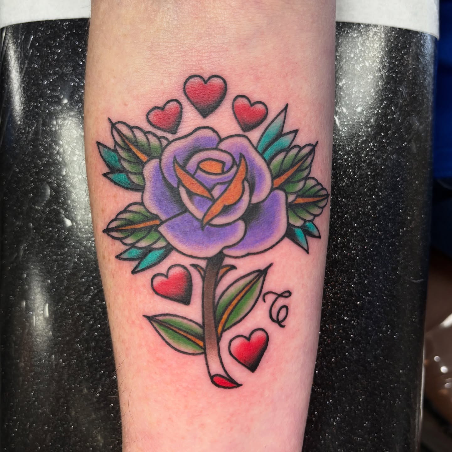 Purple rose with hearts American traditional tattoo on the forearm by @koma_tk