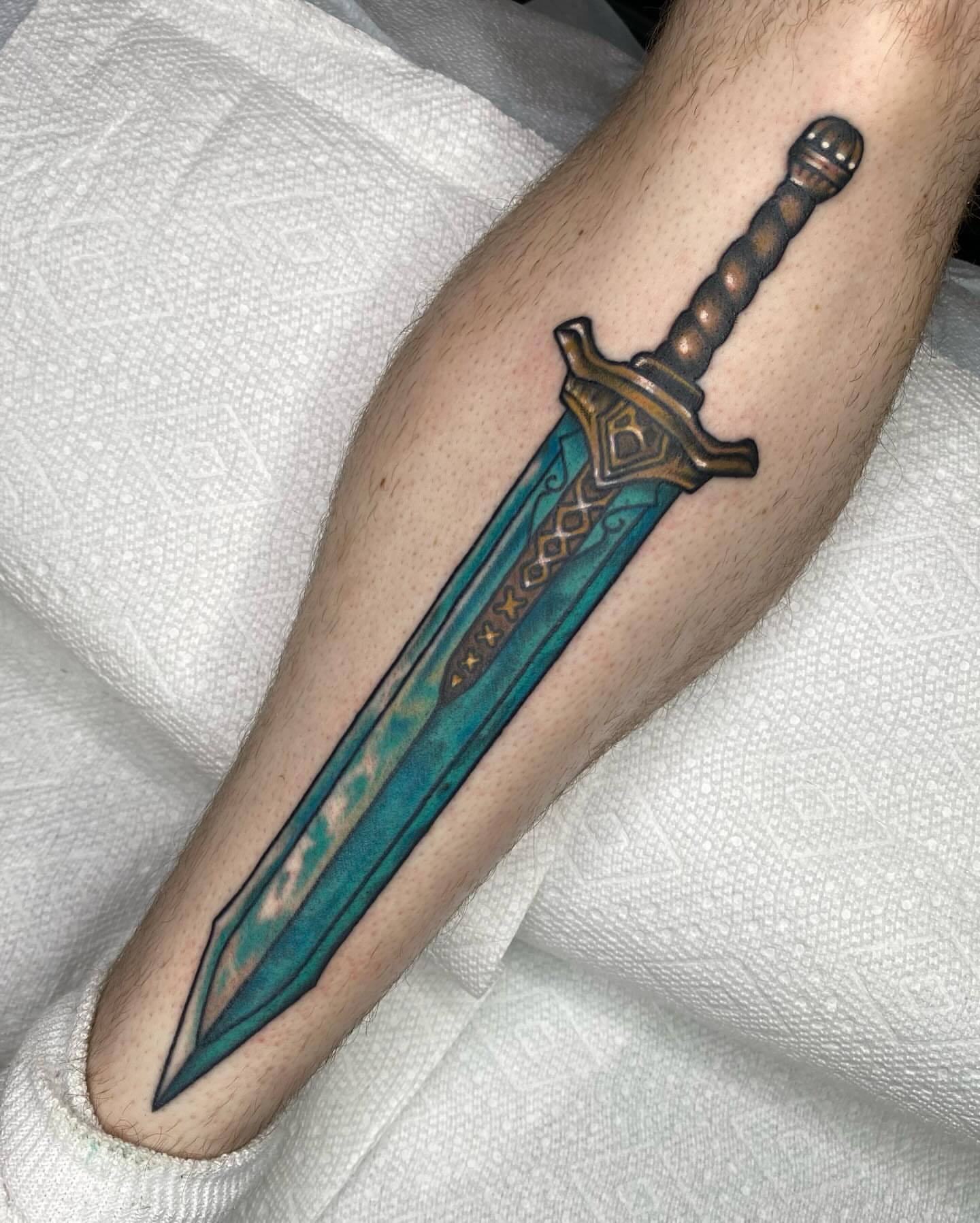 Sword realism tattoo on the forearm by Morgana Sutherland