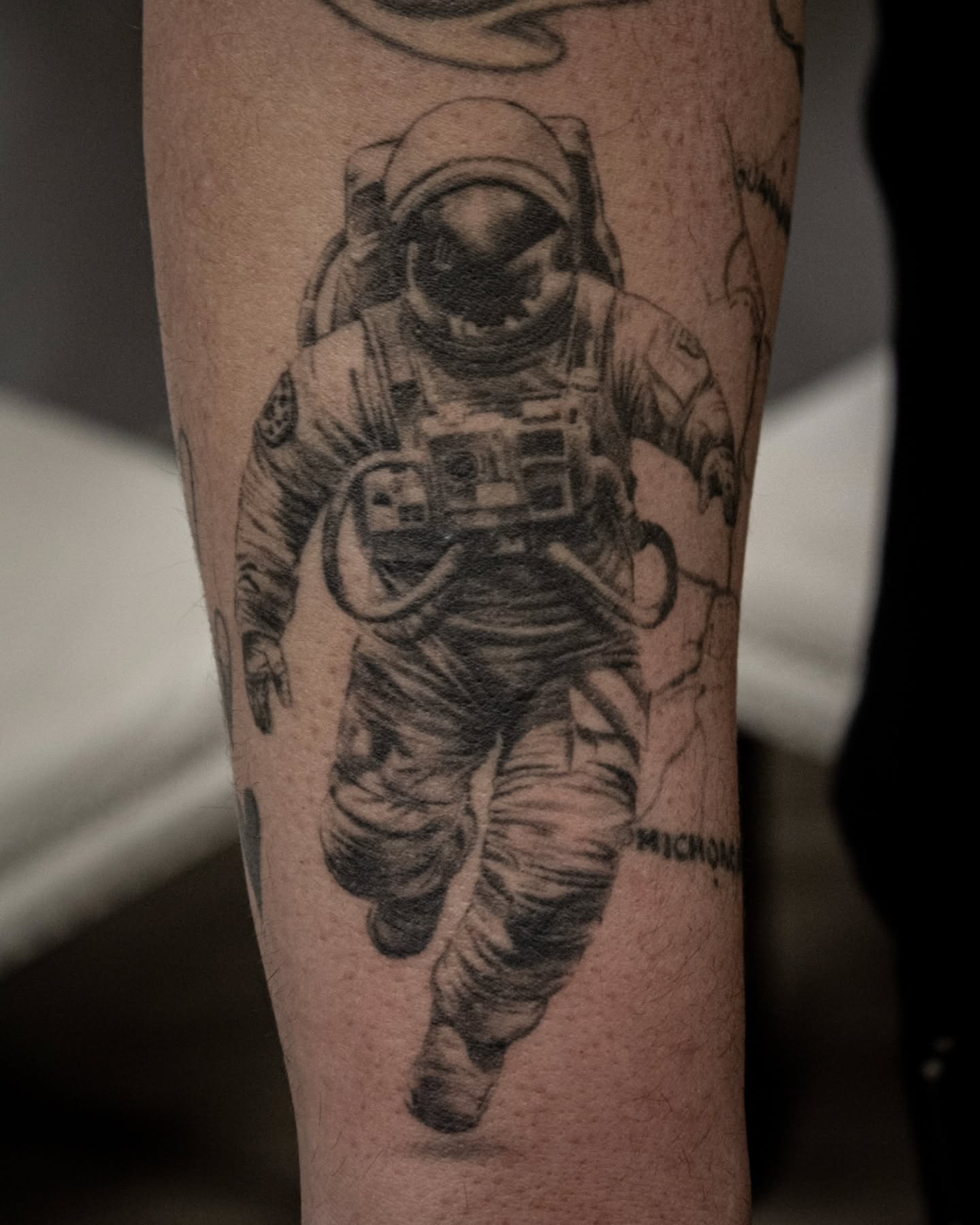 Astronaut realism tattoo on the forearm by Erik Bonilla