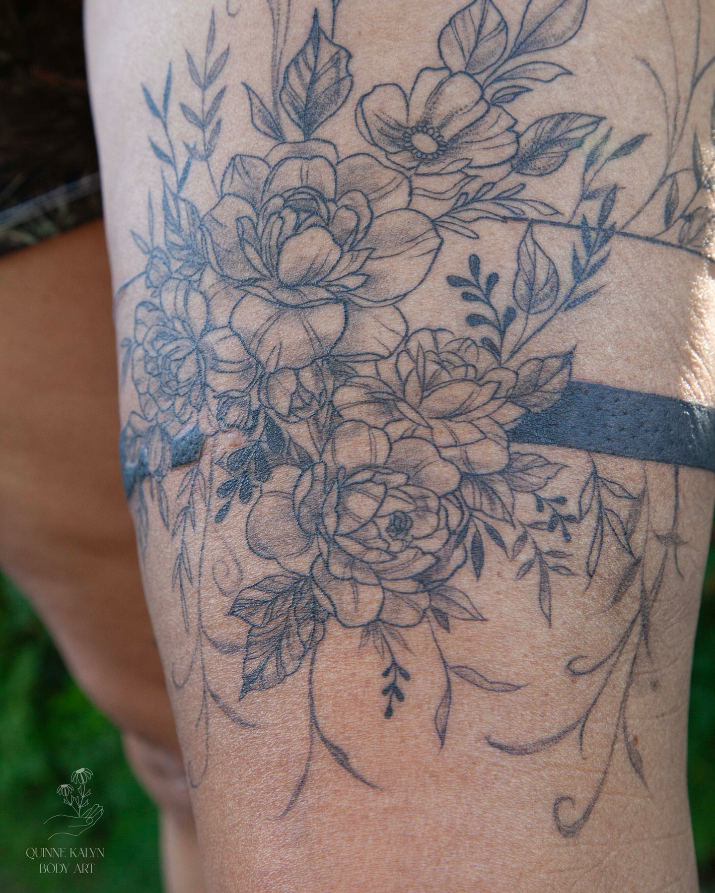 Floral bouquet black and grey tattoo on the forearm by Nashville Piercer & Tattoo Artist ✨ Quinne